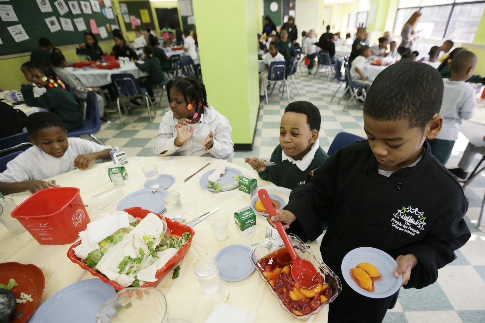FILE PHOTO: A student serves up desert to classmates during lunch at the People for People Charter School, Monday, Feb. 25, 2013, in Philadelphia. 
