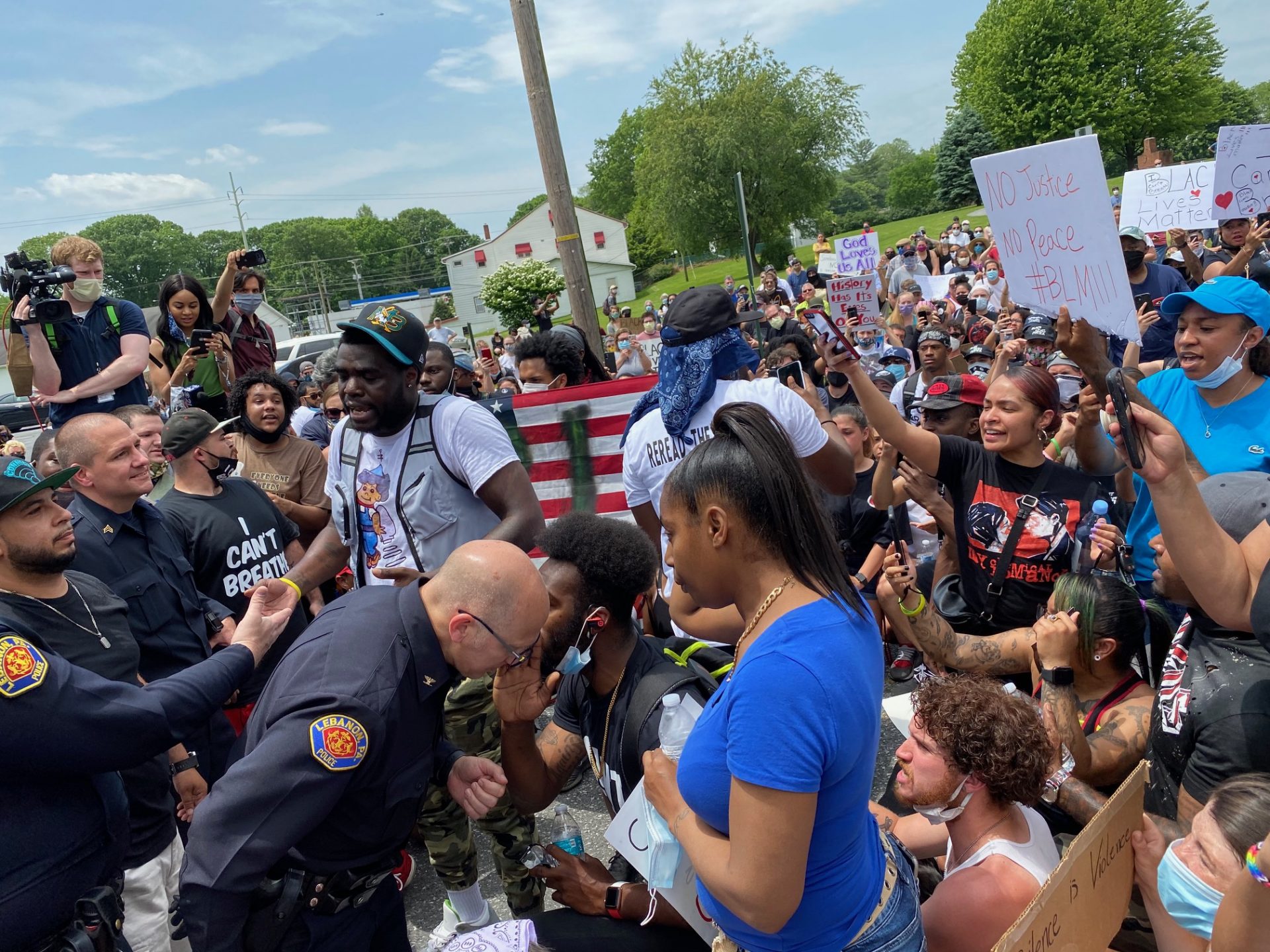 Joshua Spaulding and other protesters ask Lebanon police to kneel with them at a peaceful demonstration in front of the courthouse. 