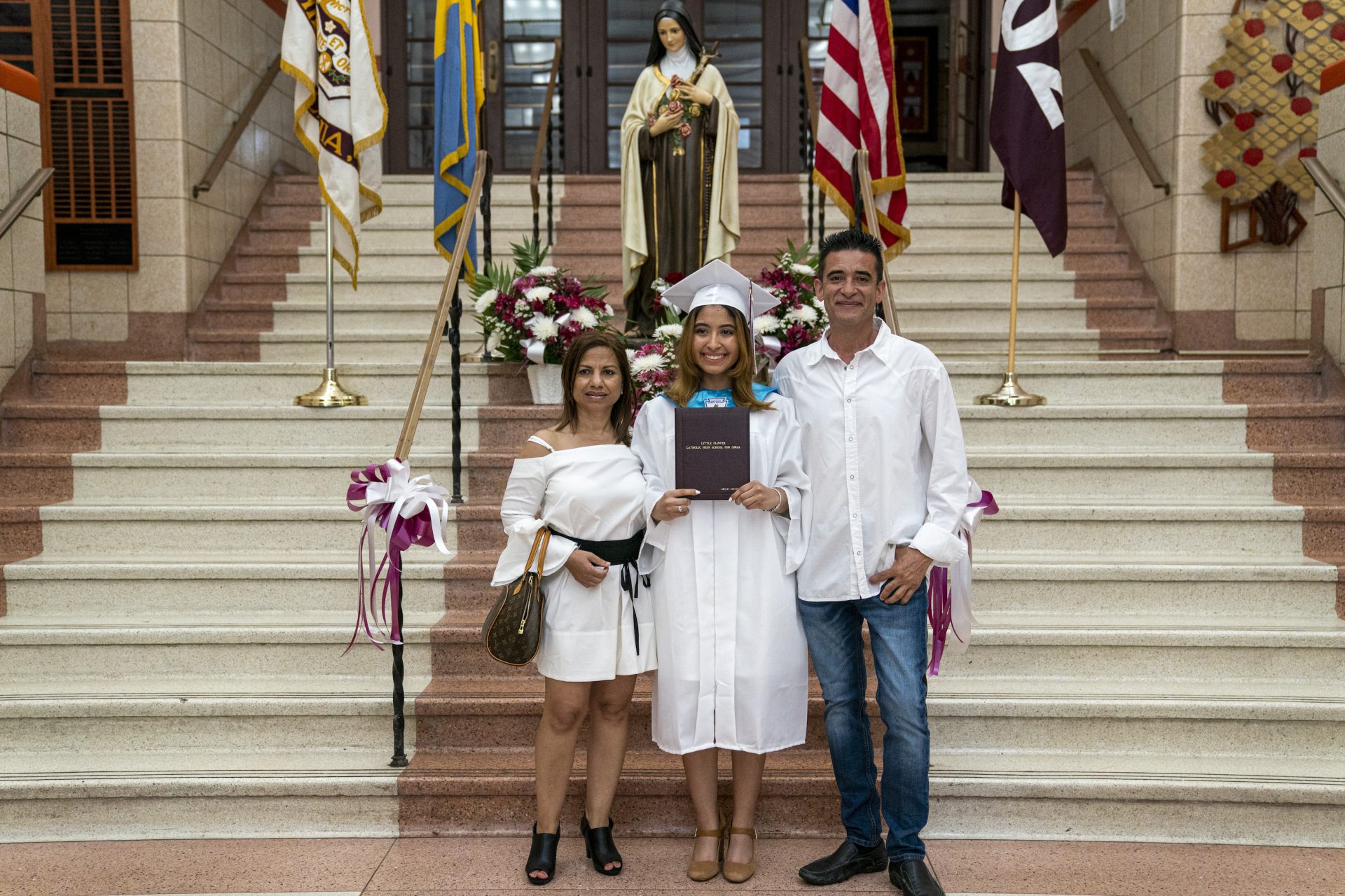 Ashley Acevedo with her parents Elena and Johnny on graduation day inside Little Flower Catholic School for Girls.