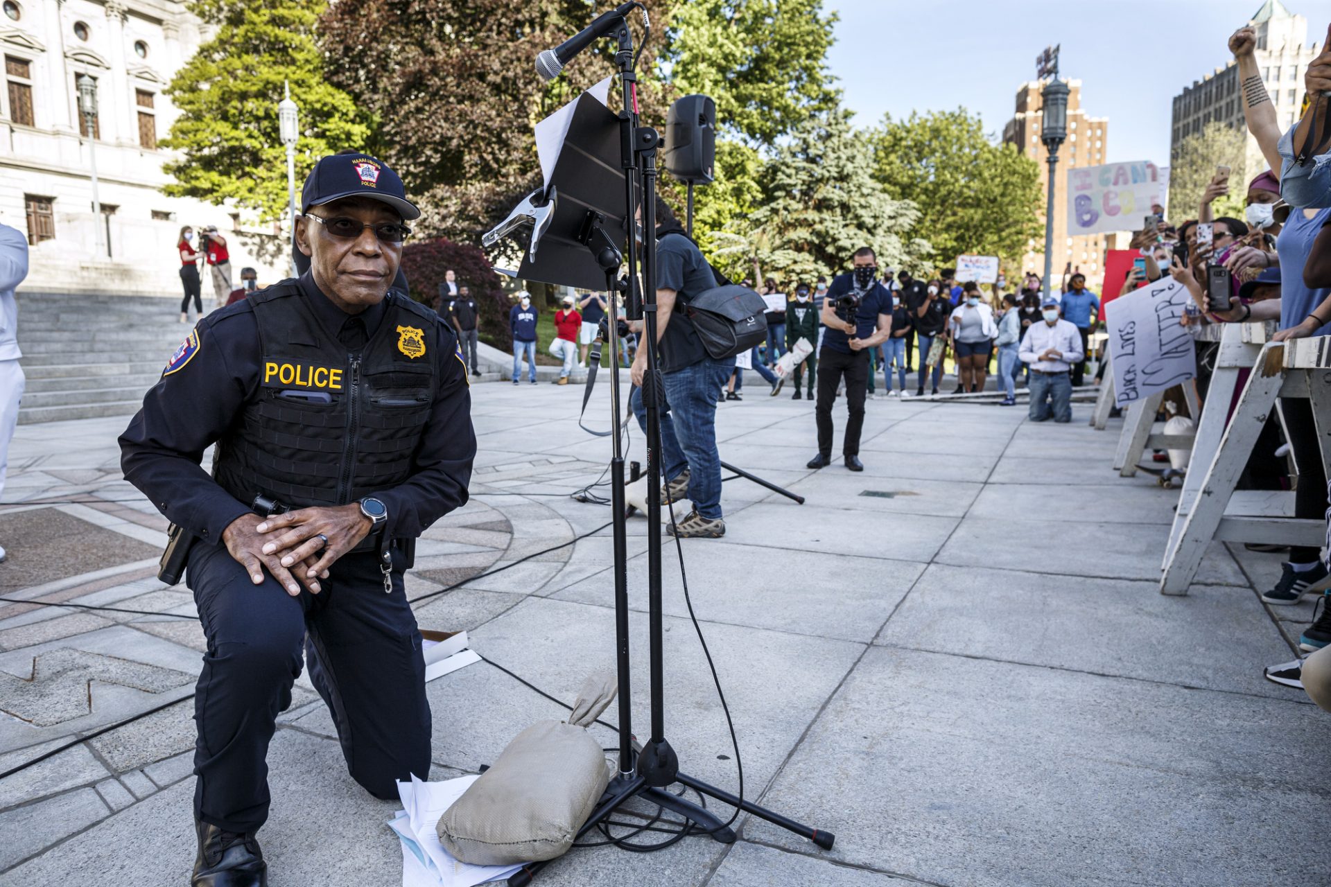 Harrisburg police chief Thomas Carter takes a knee on June 1, 2020, as he apologizes to the crowd for treatment by police at the demonstration two days prior.
