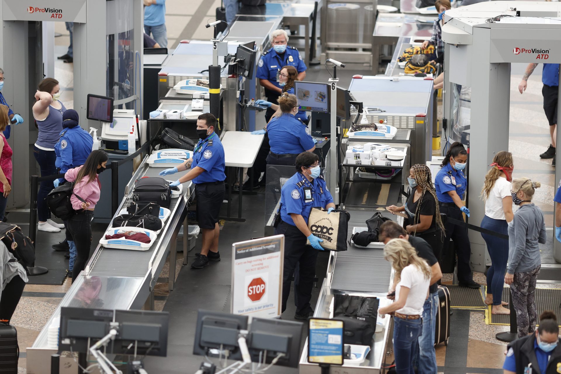 Transportation Security Administration agents work at the south security checkpoint in Denver International Airport as travellers deal with the effects of the new coronavirus Wednesday, June 10, 2020, in Denver.