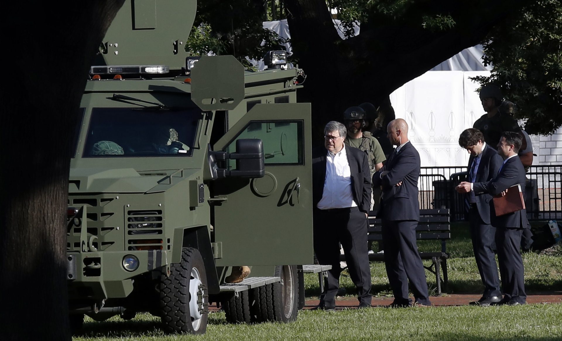 Attorney General William Barr (center) stands in Lafayette Park across from the White House as demonstrators gather to protest the death of George Floyd on Monday.