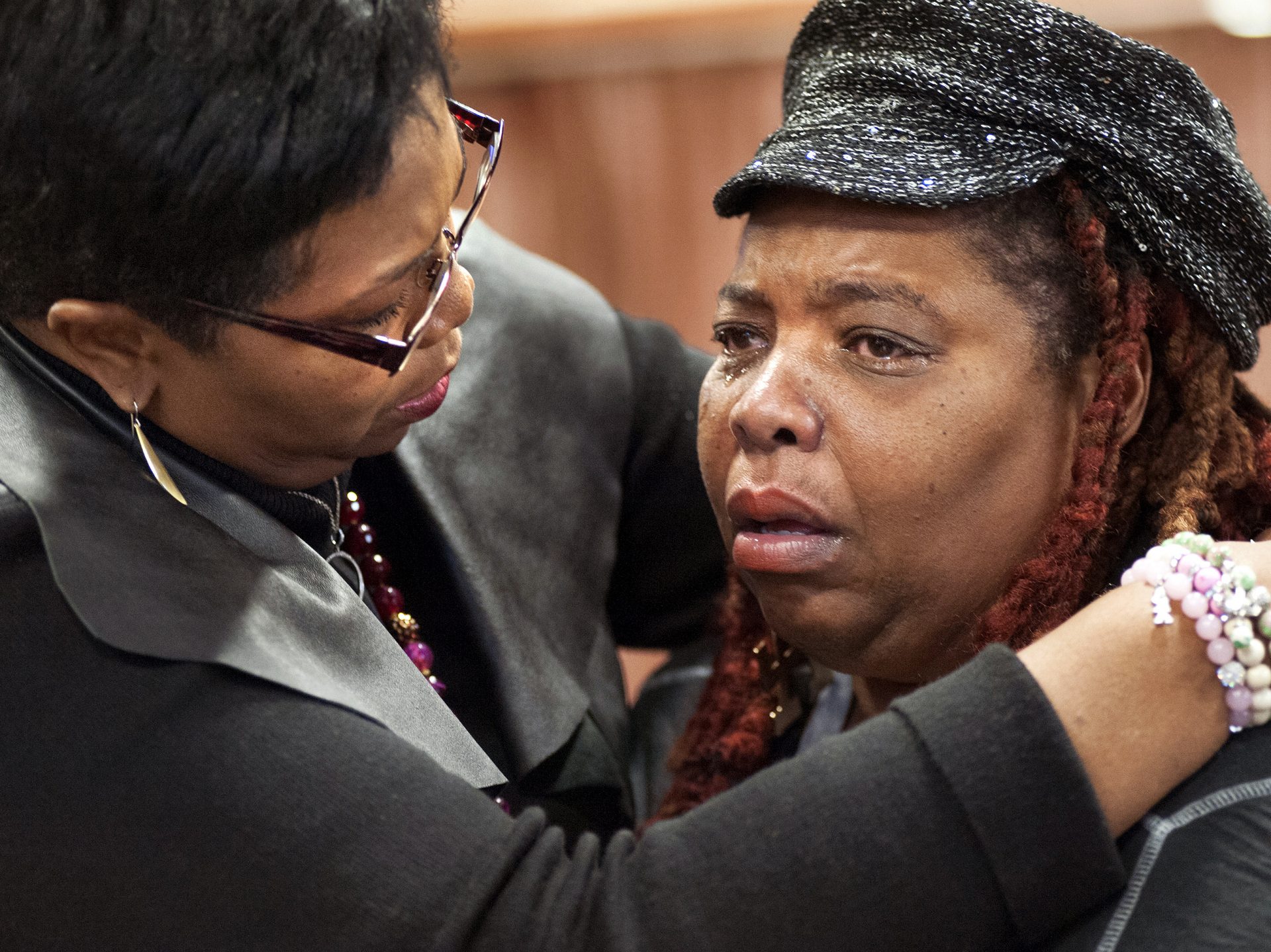 Rev. Traci Blackmon, left, comforts Dell Taylor during the opening meeting of Missouri's Ferguson Commission in 2014. "We've always had to figure out how to take care of our community, to take care of our neighborhoods and take care of our seniors," Blackmon says.