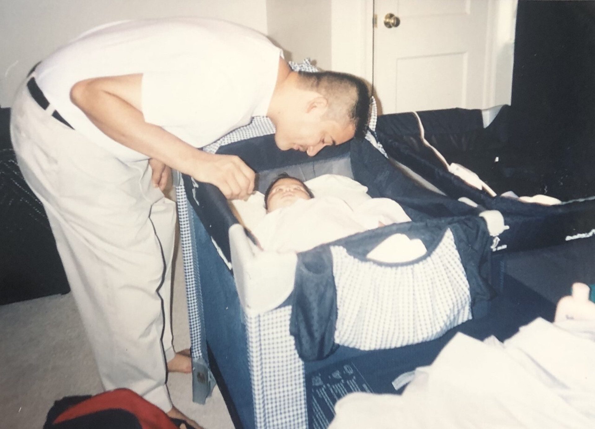 Johnny Acevedo looks over Ashley as an infant.