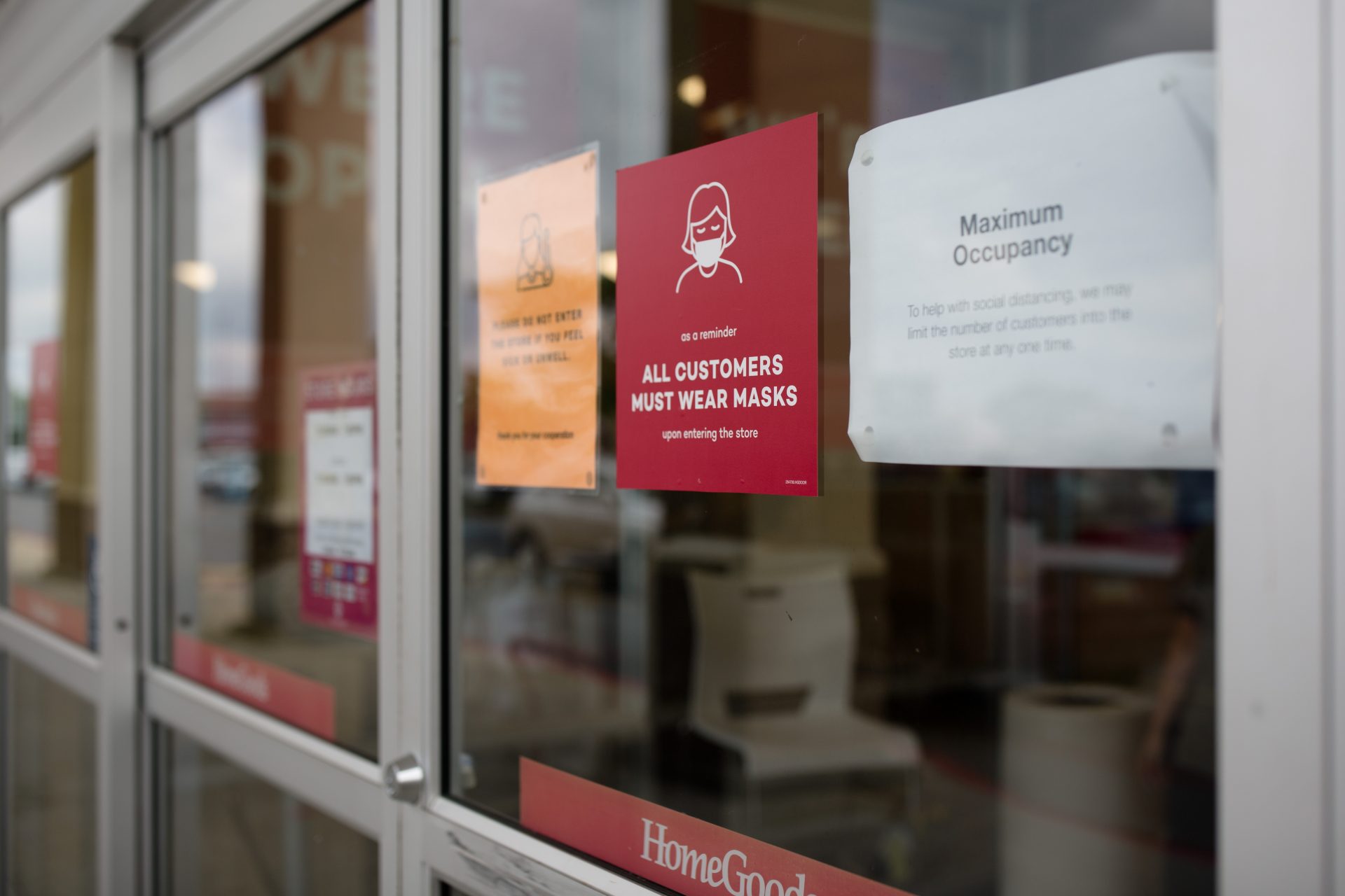 Signs directing customers to wear masks and stating occupancy limits are posted on the door of Home Goods store on Jonestown Road in Harrisburg on Friday, June 19, 2020.