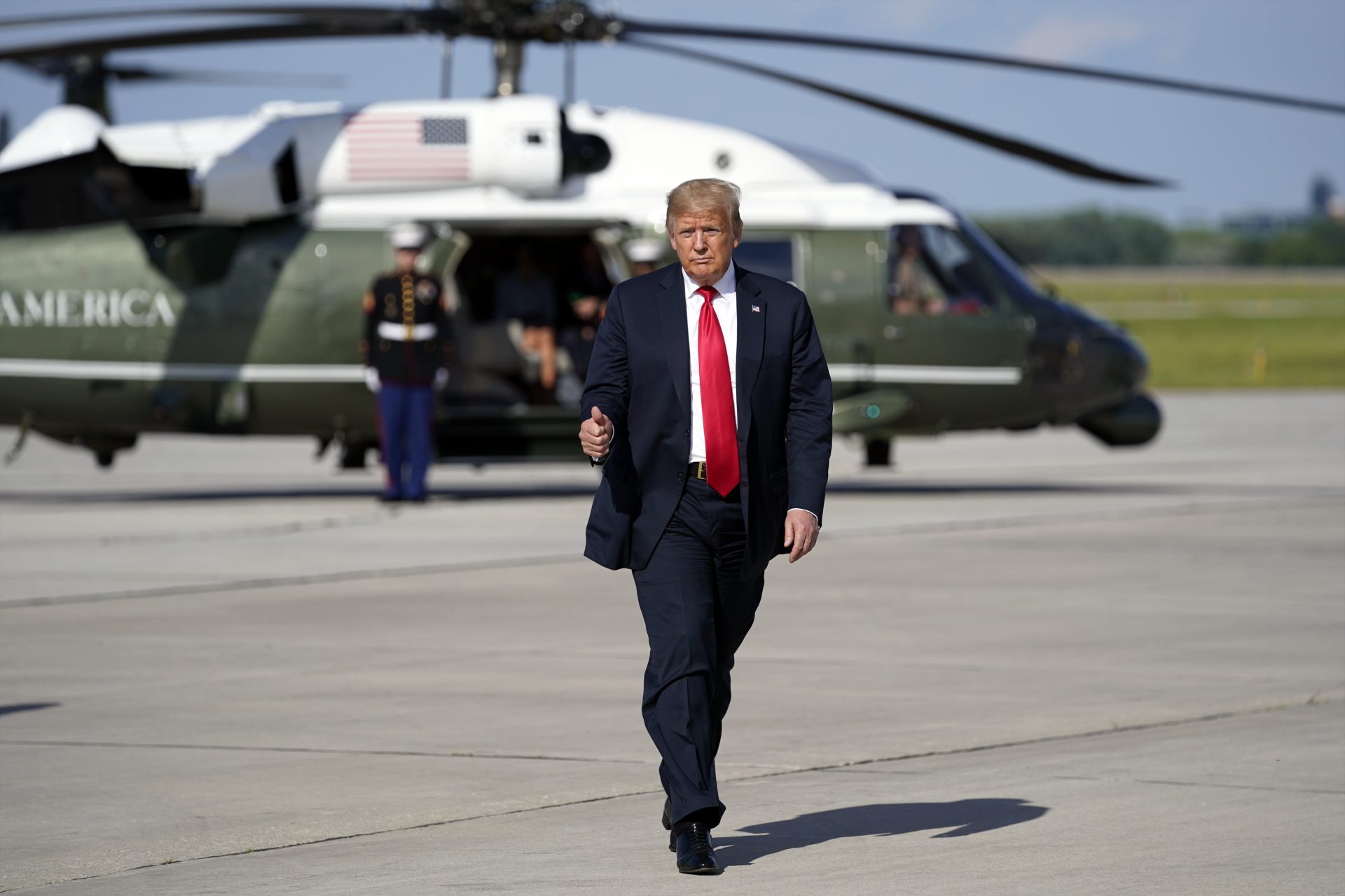 President Donald Trump gestures as he arrives on Marine One to board Air Force One to depart Green Bay, Wis., after a visit to Fincantieri Marinette Marine.