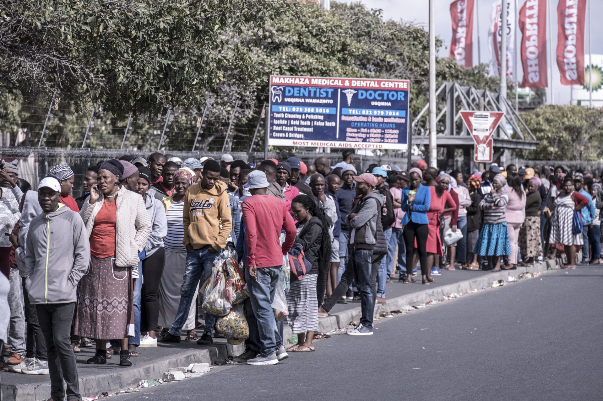 Shoppers line up for food outside a supermarket in the township of Khayelitsha in Cape Town during South Africa's lockdown.