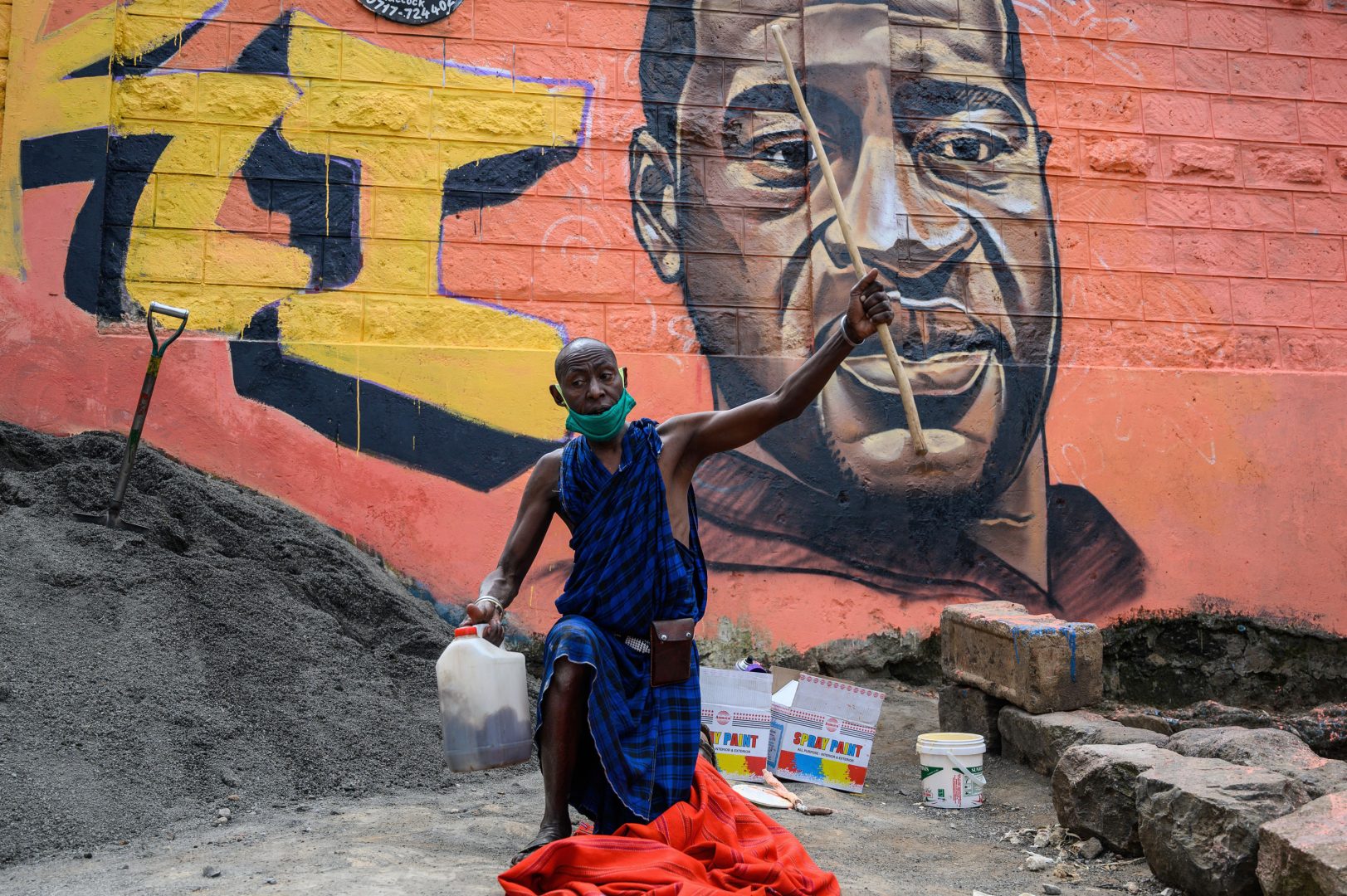A Maasai man in the Kibera slum of Nairobi, Kenya, prays next to a mural of George Floyd, painted by the artist Allan Mwangi on June 3.
