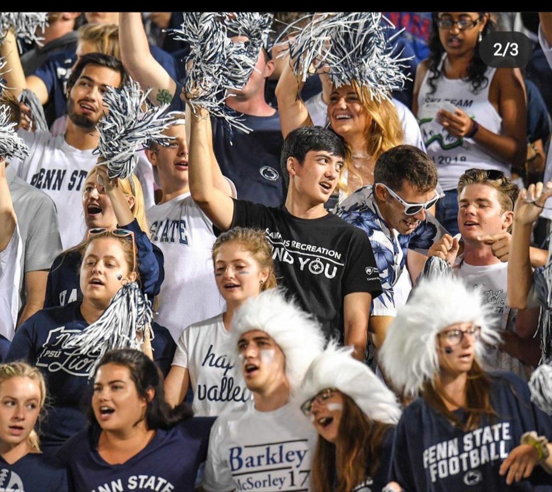 Jarod Yu (center) cheers on the Nittany Lions at a Penn State football game.
