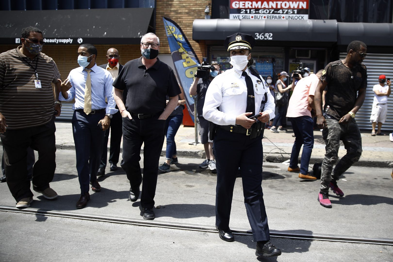 Philadelphia Police Commissioner Danielle Outlaw, center, and Mayor Jim Kenney, 4th left, meet with people, Thursday, June 4, 2020, in Philadelphia after days of protest over the May 25 death of George Floyd, who died after being restrained by police in Minneapolis. 