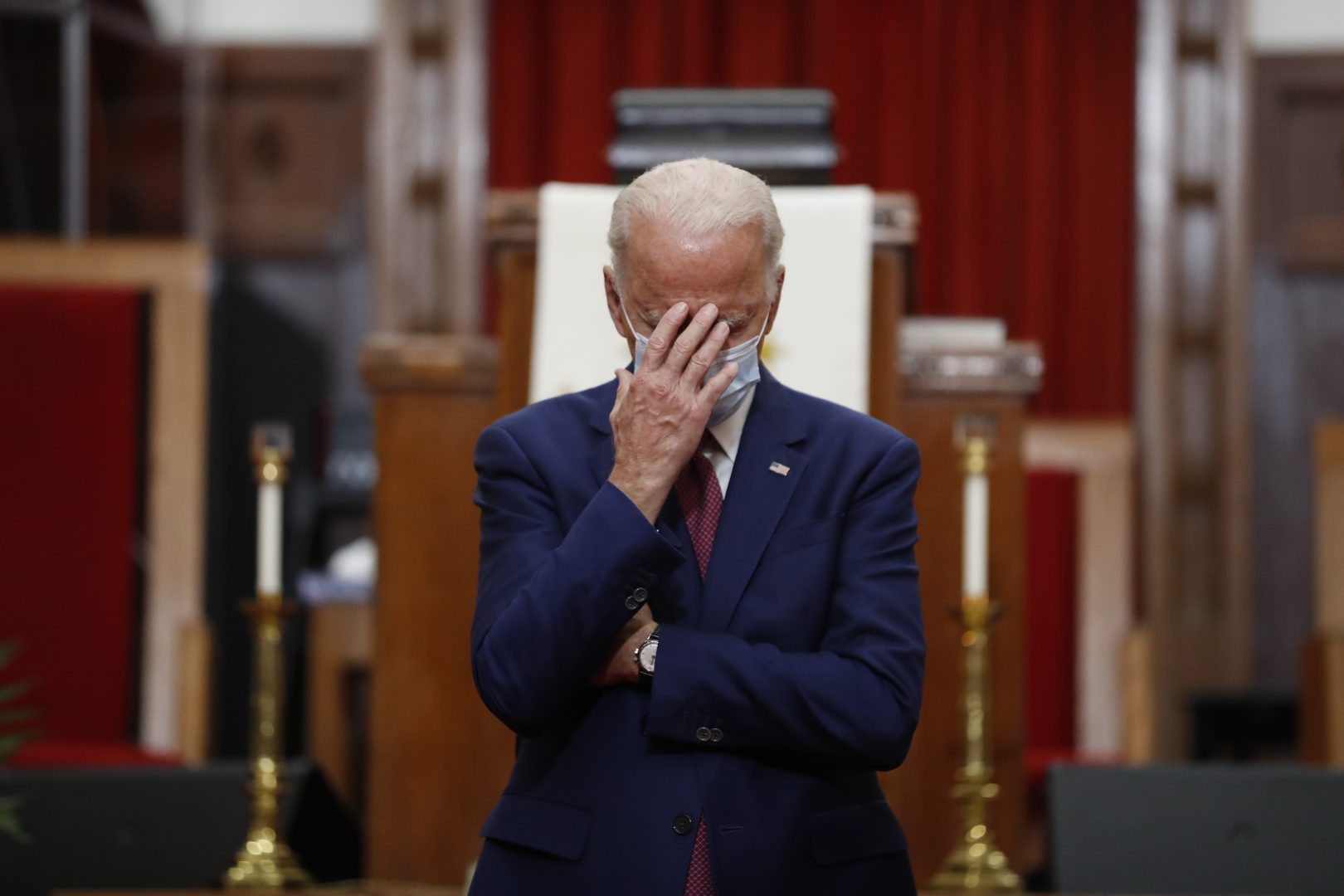 Democratic presidential candidate, former Vice President Joe Biden touches his face as he speaks to members of the clergy and community leaders at Bethel AME Church in Wilmington, Del., Monday, June 1, 2020. (