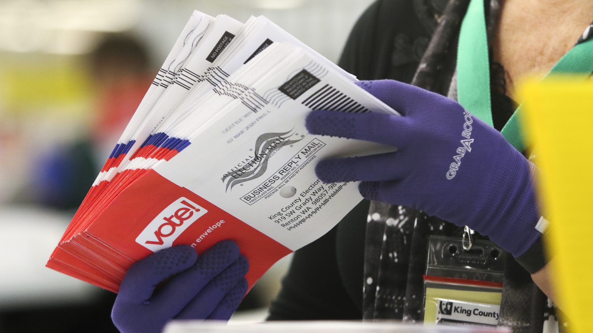 An election worker sorts vote-by-mail ballots for the presidential primary in Washington on March 10.