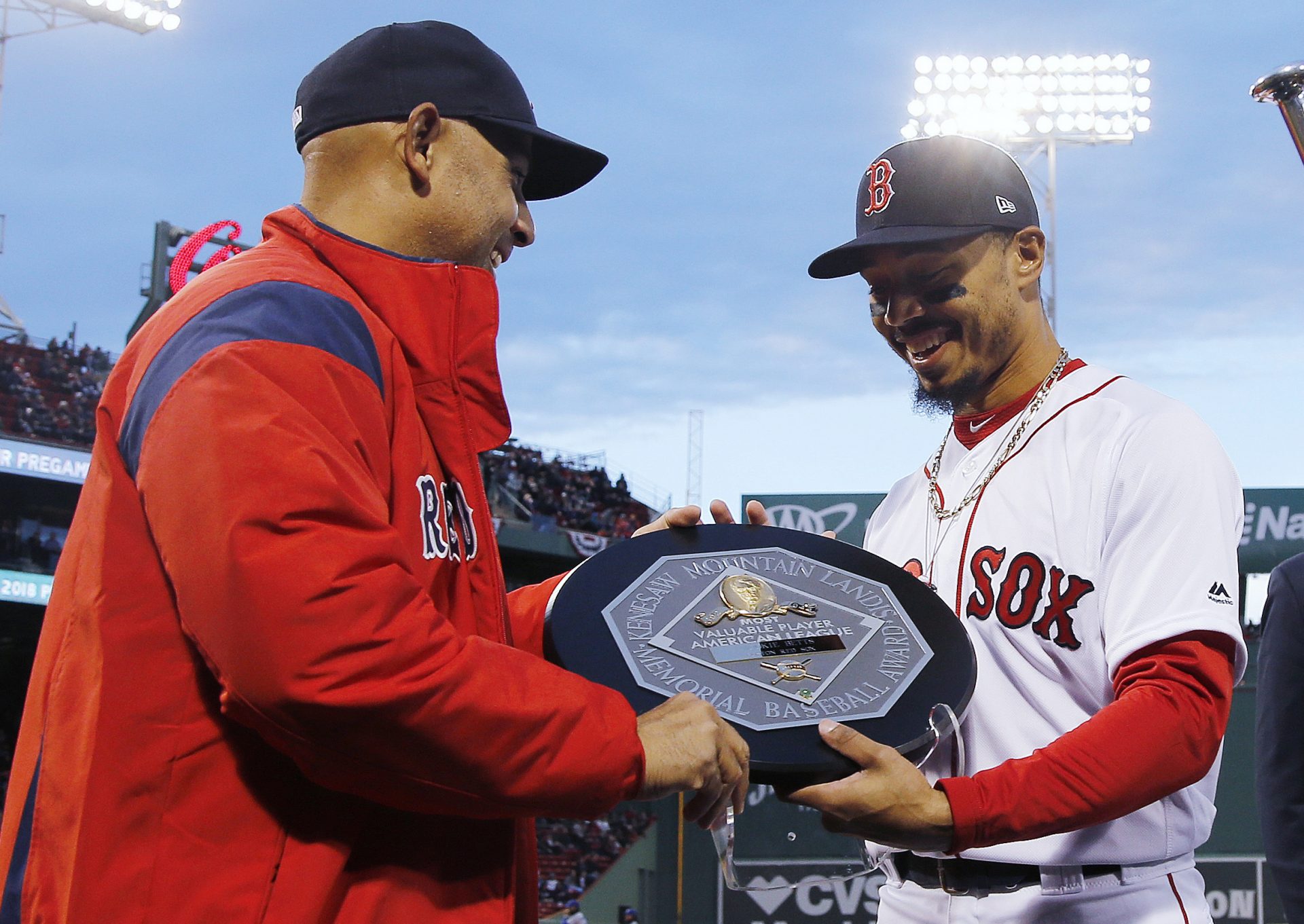 FILE - In this April 11, 2019, file photo, Boston Red Sox manager Alex Cora, left, presents right fielder Mookie Betts with the 2018 AL MVP Award before a baseball game between the Red Sox and the Toronto Blue Jays at Fenway Park in Boston. The award includes the name and image of Kenesaw Mountain Landis.