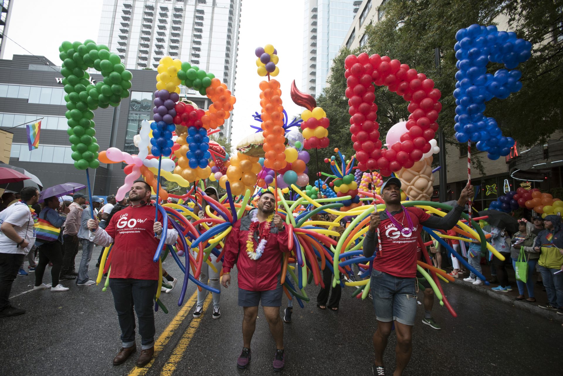 Employees from a local business supporting LGBTQ rights march during the city's annual Gay Pride parade on Sunday, Oct. 13, 2019, in Atlanta.
