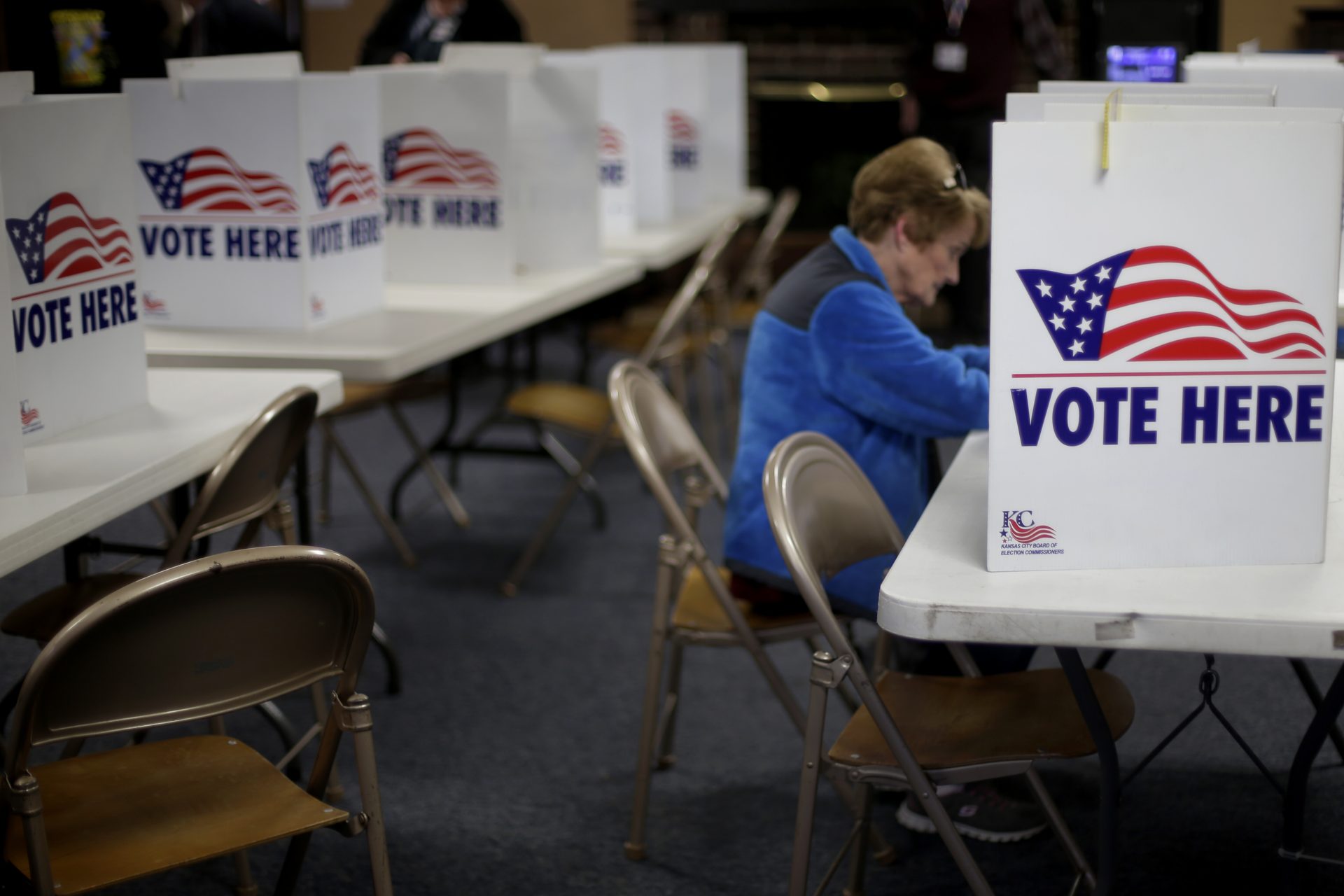 FILE - In this March 10, 2020, file photo a woman votes in the presidential primary election at the the Summit View Church of the Nazarene in Kansas City, Mo. A Federal appeals court ruled Wednesday, April 29, 2020, that proof of citizenship requirement for Kansas voter registration is unconstitutional.