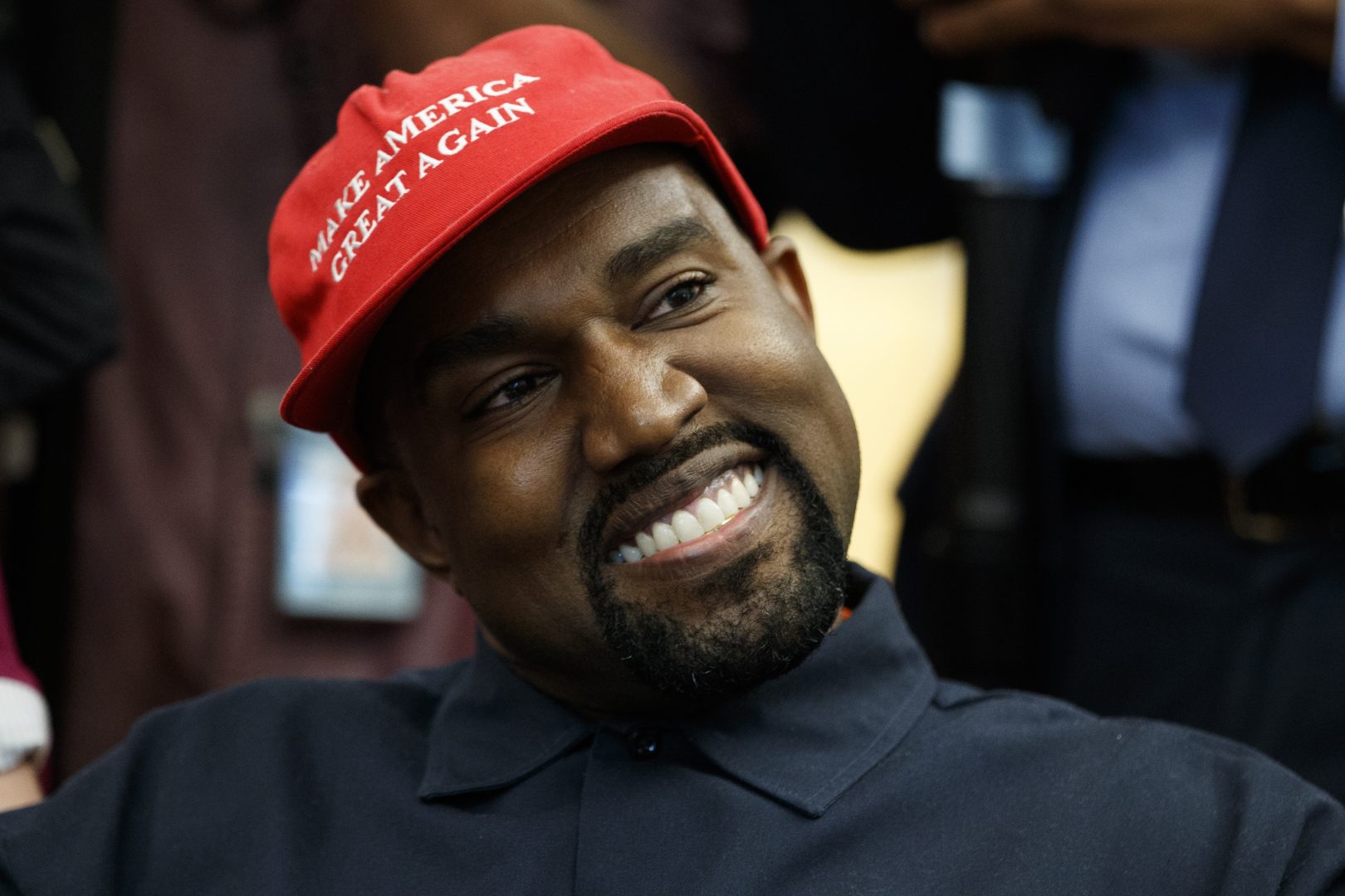 Rapper Kanye West smiles as he listens to a question from a reporter during a meeting in the Oval Office of the White House with President Donald Trump, Thursday, Oct. 11, 2018, in Washington. (AP Photo/Evan Vucci)