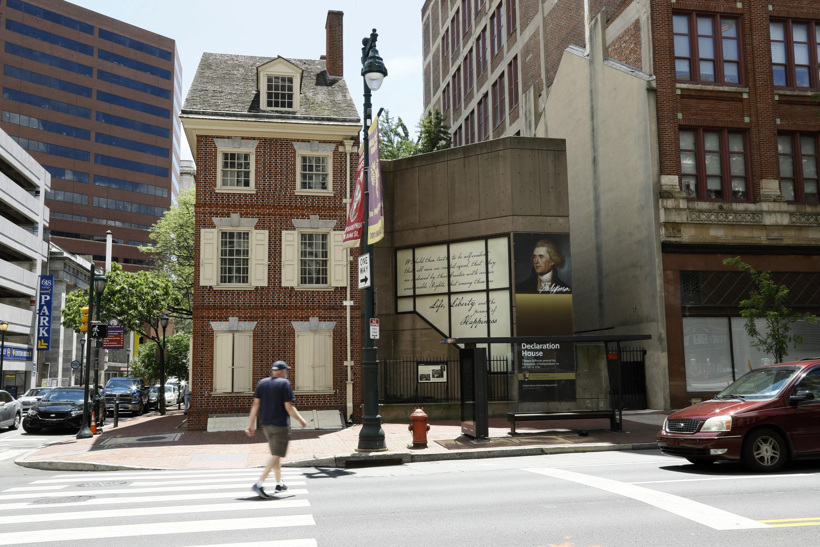 In this June 30, 2020, photo, a man walks in front of the Declaration House in Philadelphia. Countless words have been written about the Declaration of Independence and Thomas Jefferson, but few about Robert Hemings, the slave who was on hand as Jefferson famously declared that “All men are created equal.”  According to the National Park Service, Hemings is not included in the exhibit texts of the Declaration House, a reconstruction of the home Jefferson stayed in as a guest of the Philadelphia bricklayer Jacob Graff.