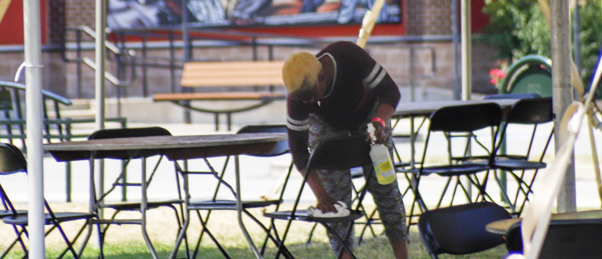 Kay Hamilton cleans and sterilizes a covered outdoor area where patrons who purchased meals from the surrounding restaurants can sit and eat their takeout food, Friday, July 3, 2020, in McCandless, Pa. In response to a spike in COVID-19 cases in Allegheny County, which encompasses McCandless and the Pittsburgh areas, the county's Health Department closed bars and restaurants for a week, starting Friday, although they can still provide takeout and delivery.