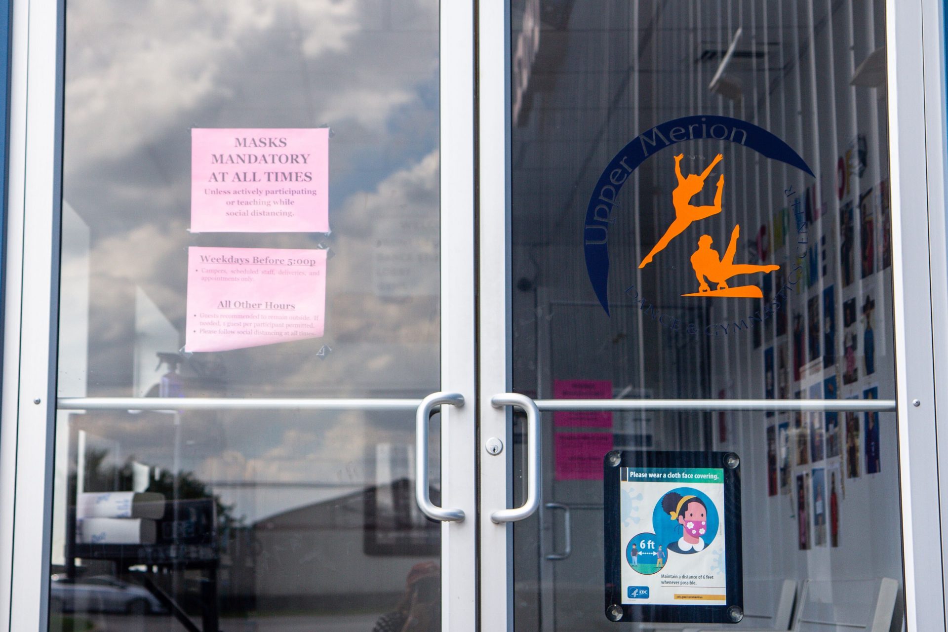 Signs at the Upper Merion Dance and Gymnastics Center call for cloth masks to be worn when in the building.