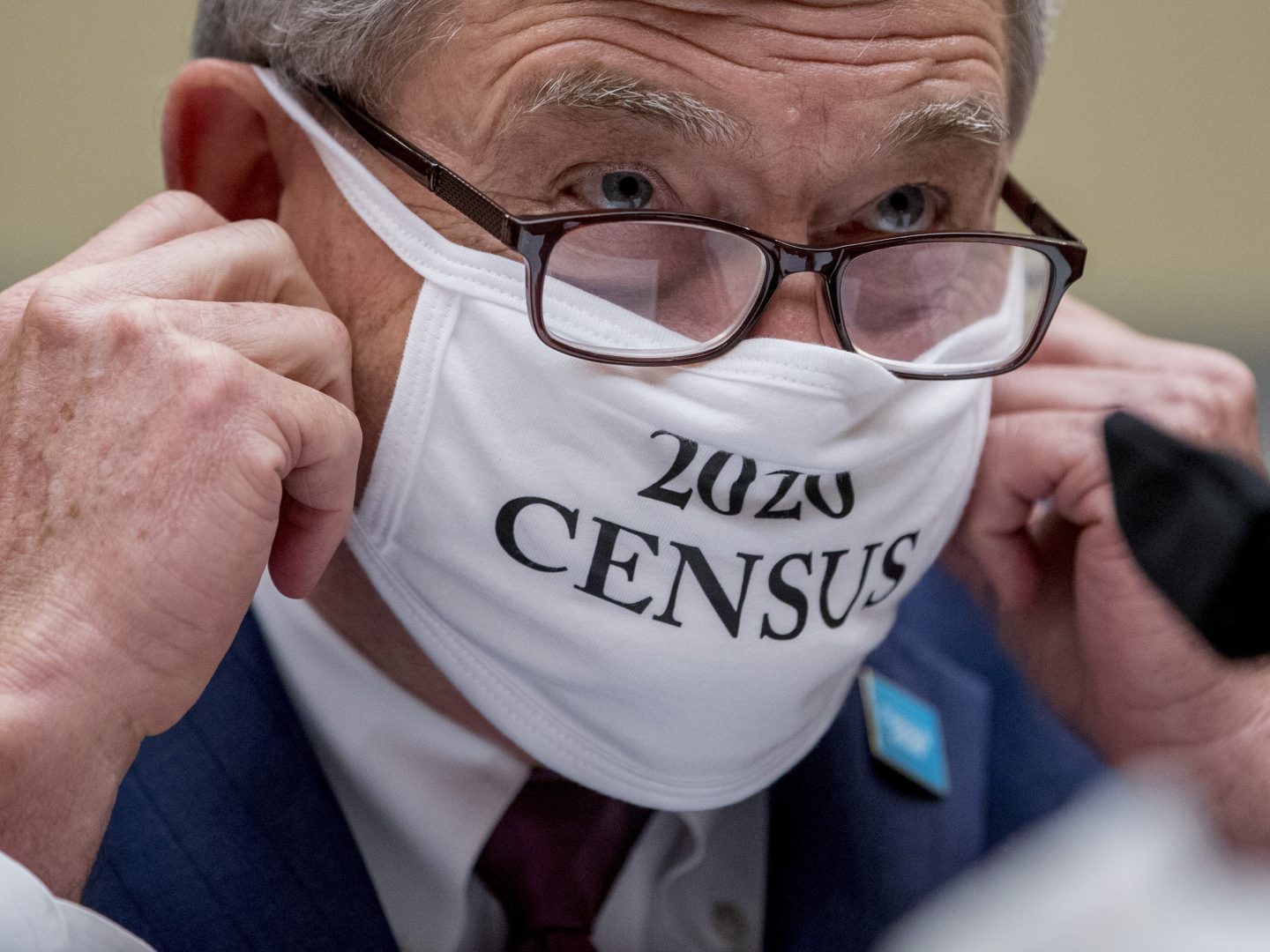 Census Bureau Director Steven Dillingham, wearing a face covering printed with the words 