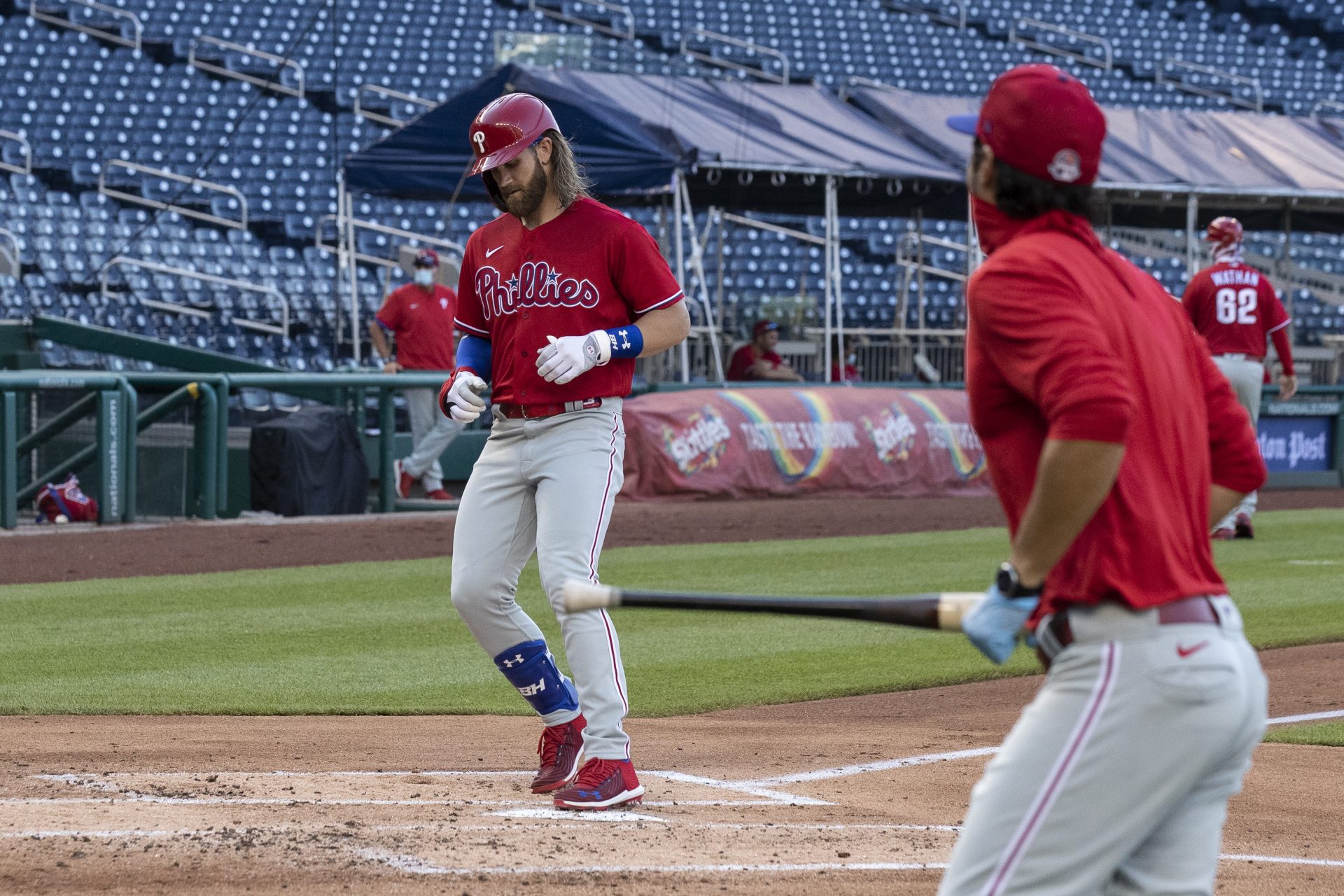 Philadelphia Phillies' Bryce Harper comes home for his three-run homer during the second inning of an exhibition baseball game against the Washington Nationals at Nationals Park, Saturday, July 18, 2020, in Washington. The Phillies won 7-2.