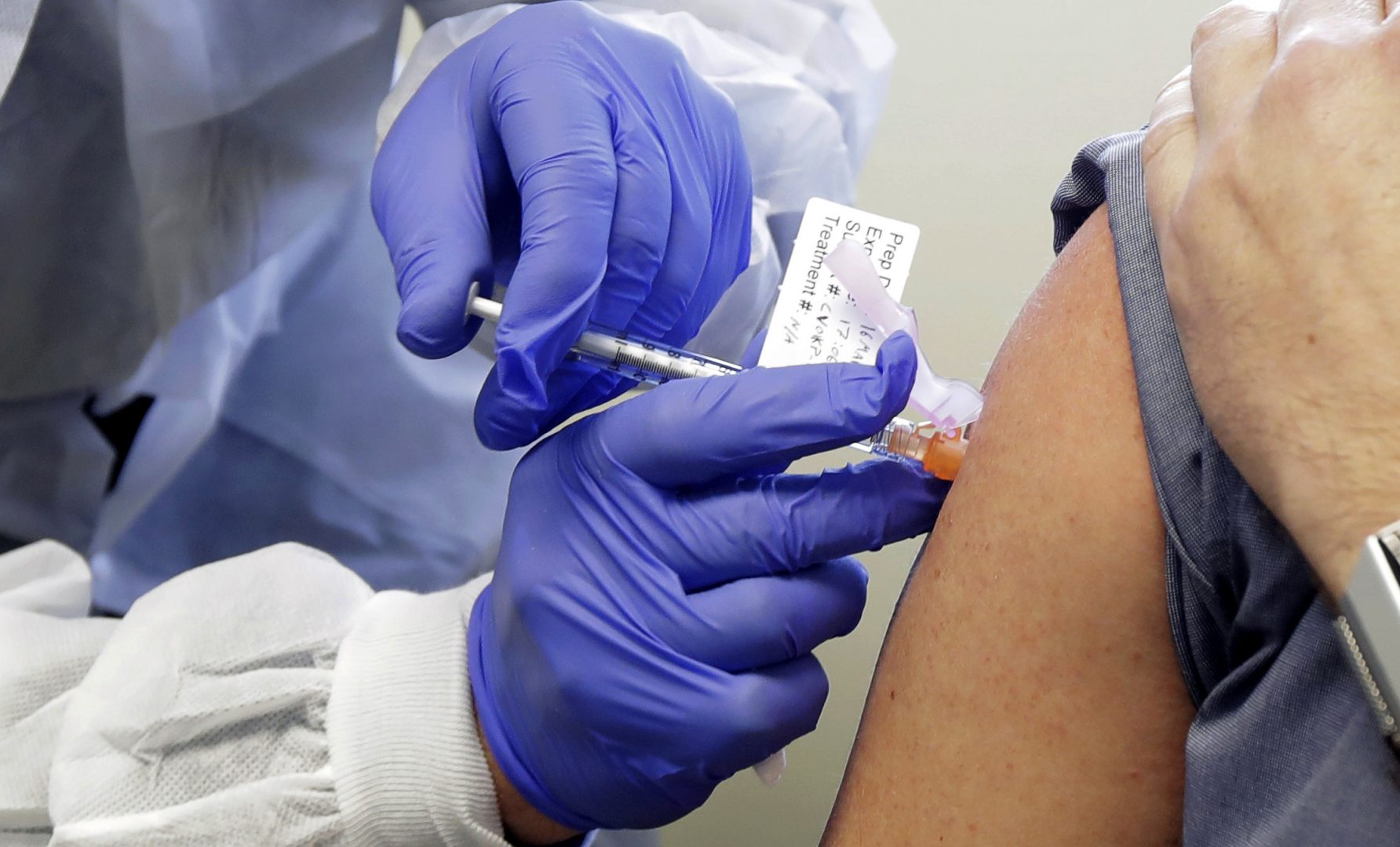 A patient receives a shot in a clinical trial for a potential coronavirus vaccine.