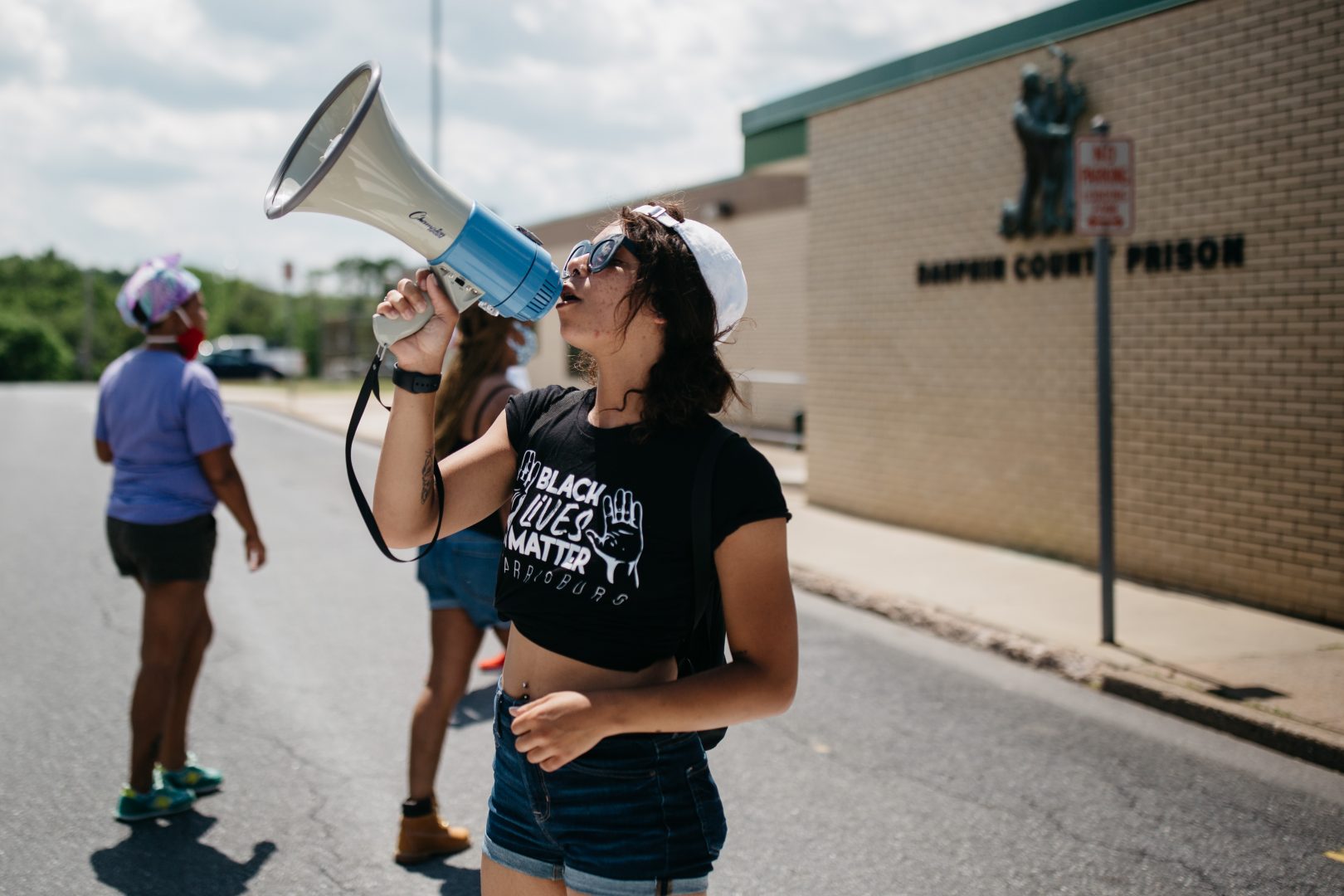 A protester with Black Lives Matter Harrisburg takes part in a protest outside Dauphin County Prison on June 30, 2020. Inmates inside the facility could be heard banging on the windows and holding up signs pleading for help. (Kate Landis, PA Post)