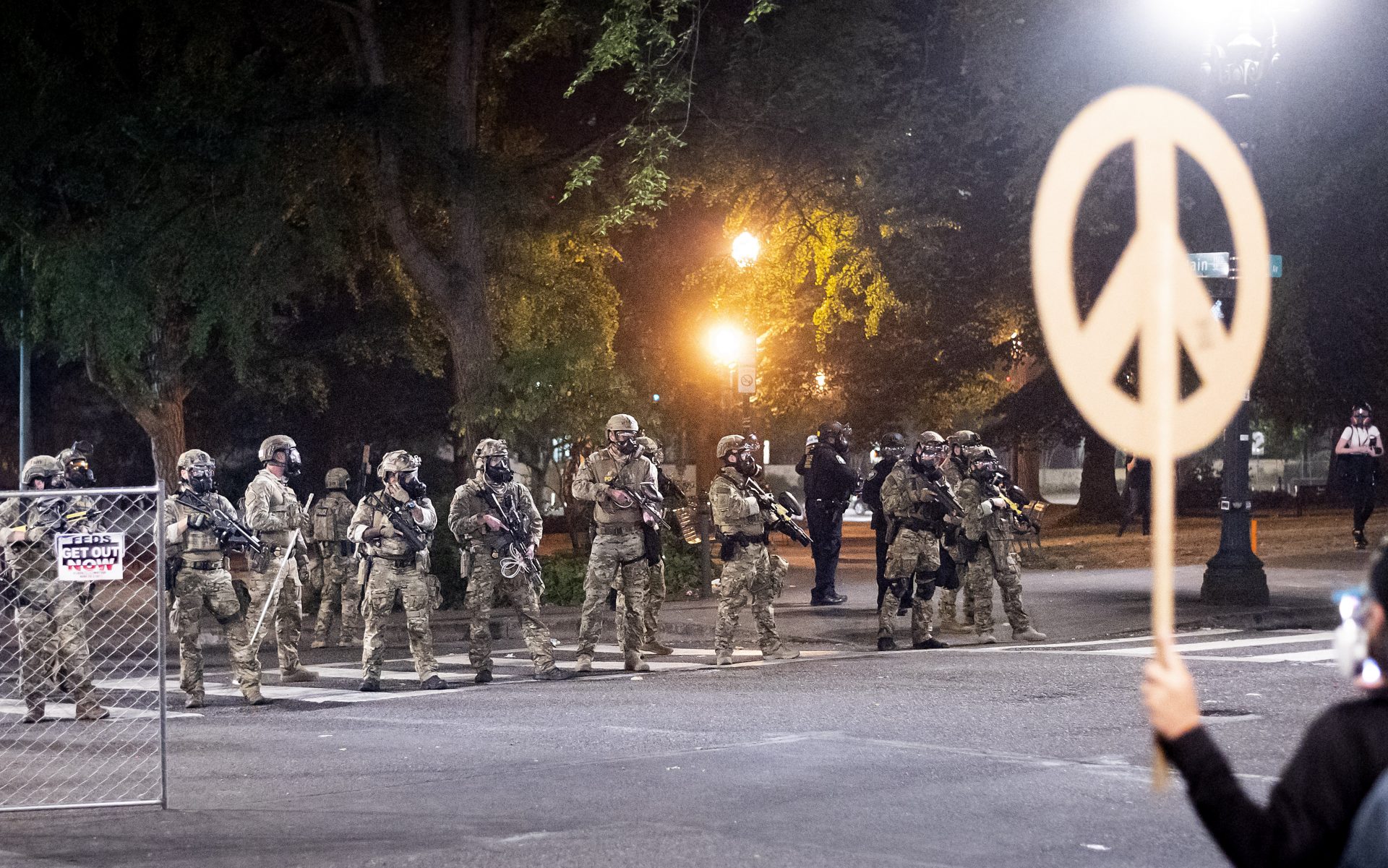 Federal agents disperse Black Lives Matter protesters near the Mark O. Hatfield United States Courthouse on Monday, July 20, 2020, in Portland, Ore. Officers used teargas and projectiles to move the crowd after some protesters tore down a fence fronting the courthouse.