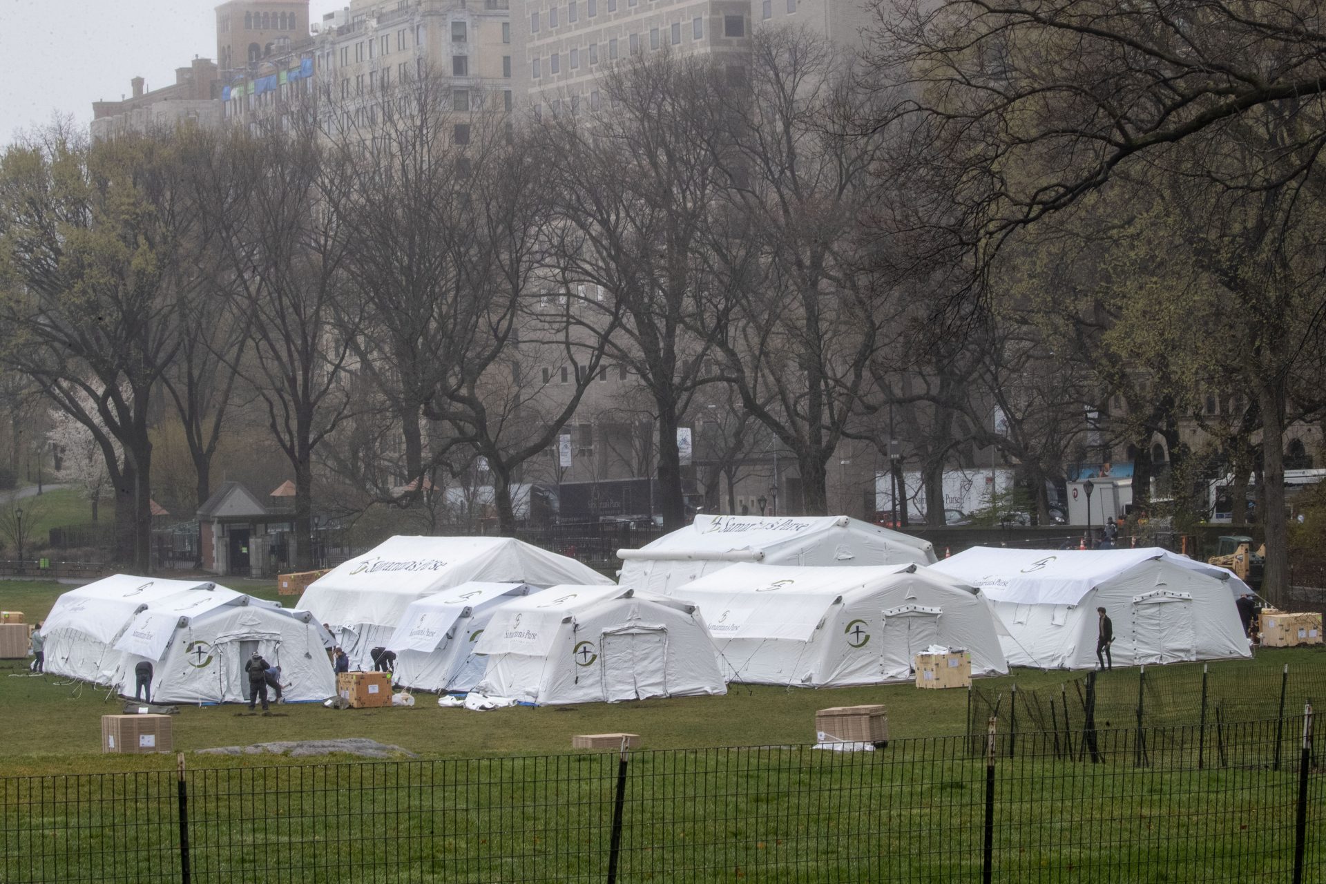 A Samaritan's Purse crew works on building an emergency field hospital specially equipped with a respiratory unit in New York's Central Park across from The Mount Sinai Hospital, Sunday, March 29, 2020.