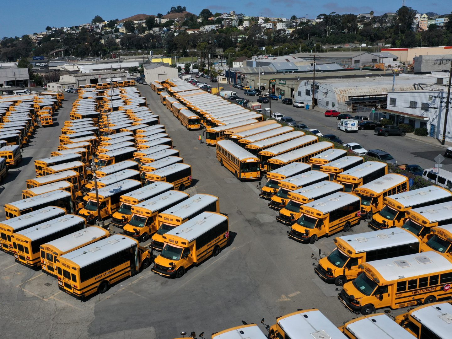 School buses sit parked in a lot at First Student Charter Bus Rental on July 14 in San Francisco, California. Los Angeles and San Diego public schools announced they will only offer a remote-only return to school August as coronavirus COVID-19 cases continue to rise in Southern California.