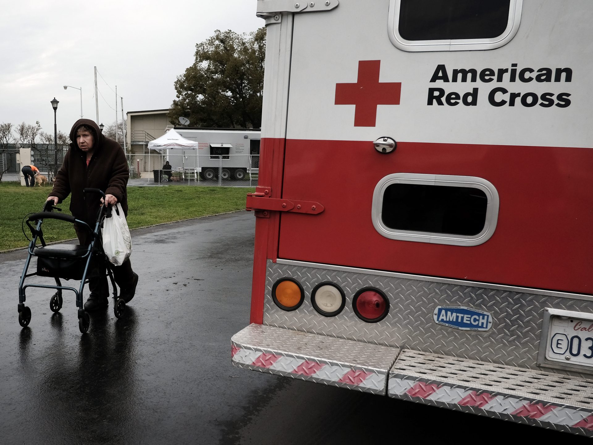 An evacuee walks past an American Red Cross vehicle at an evacuation center in Chico, Calif., on Feb. 15, 2017. Flooding had damaged the nearby Oroville Dam and there was danger it might break. Around 188,000 people were evacuated, but the dam held.