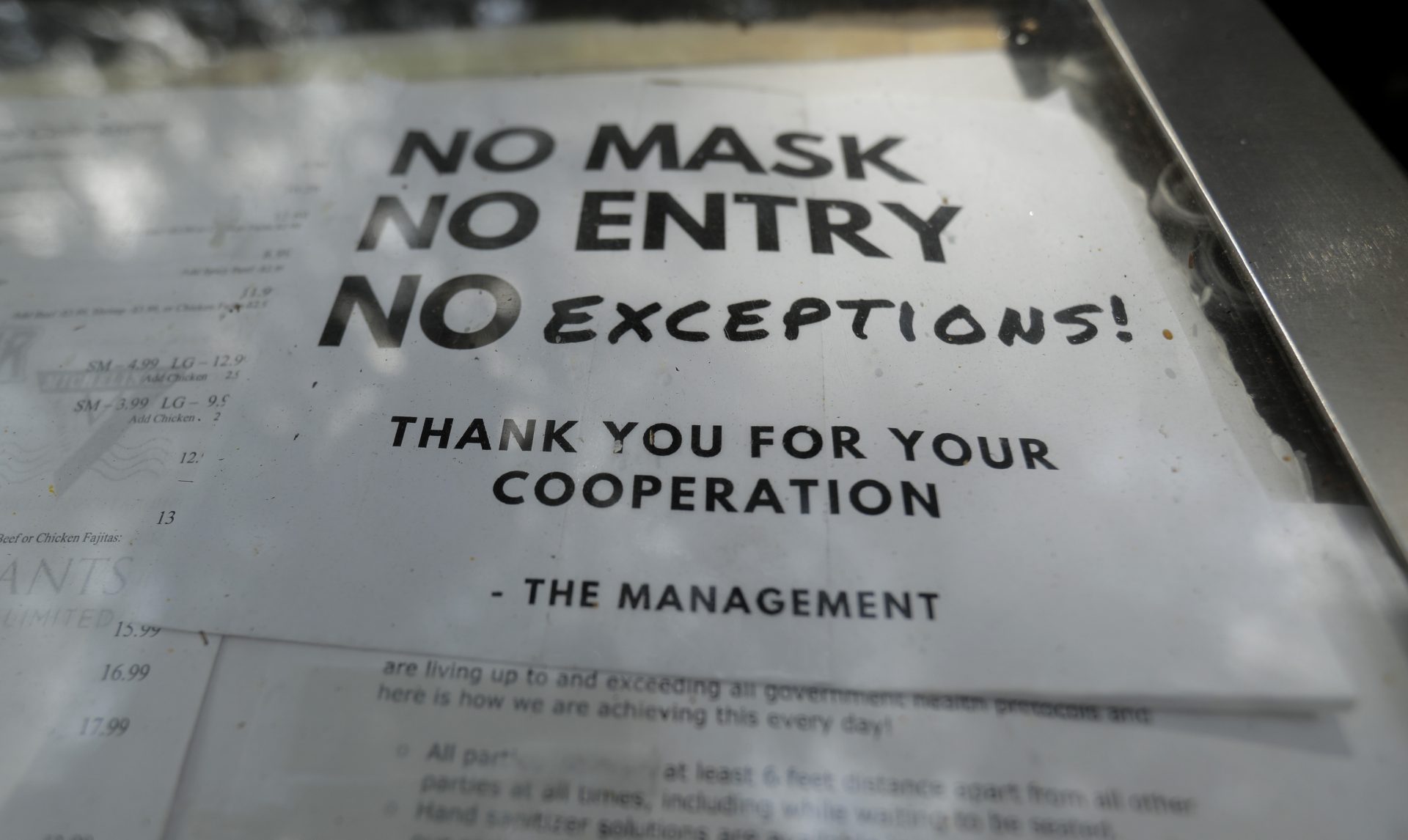 A sign requiring face masks to protect against the spread of COVID-19 is seen at a restaurant, Tuesday, July 7, 2020, in San Antonio. Texas Gov. Greg Abbott has declared masks or face coverings must be worn in public across most of the state as local officials across the state say their hospitals are becoming increasingly stretched and are in danger of becoming overrun as cases of the coronavirus surge.