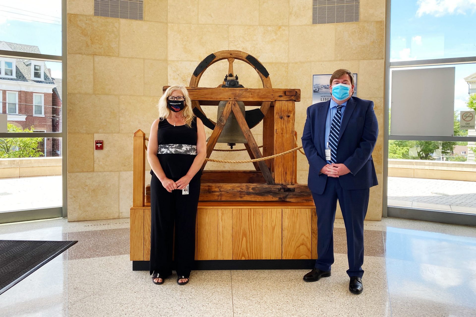 Amy Hess (left), deputy registrar of elections for Northampton County, says extracting, unfolding and flattening out ballots is the most time-consuming part of vote counting. She's shown here with Lamont McClure, county executive.