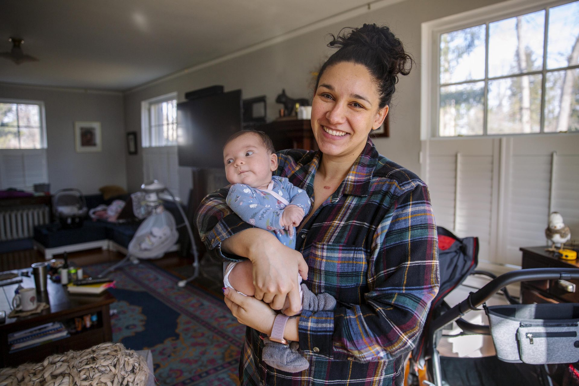 Courtney Witmer posed with her daughter, Arya, in their State College home in February. Witmer is glad Penn State will begin to offer four weeks of paid parental leave to its staff.