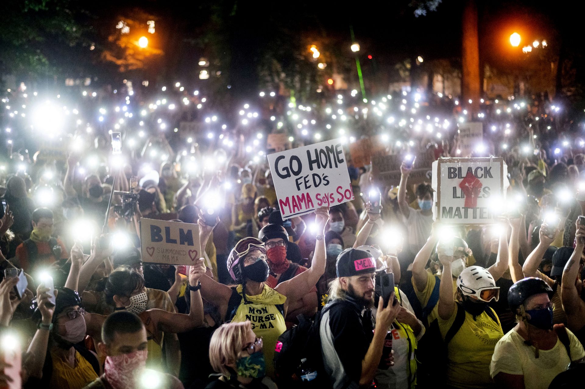 Hundreds of Black Lives Matter protesters hold their phones aloft on Monday, July 20, 2020, in Portland, Ore.