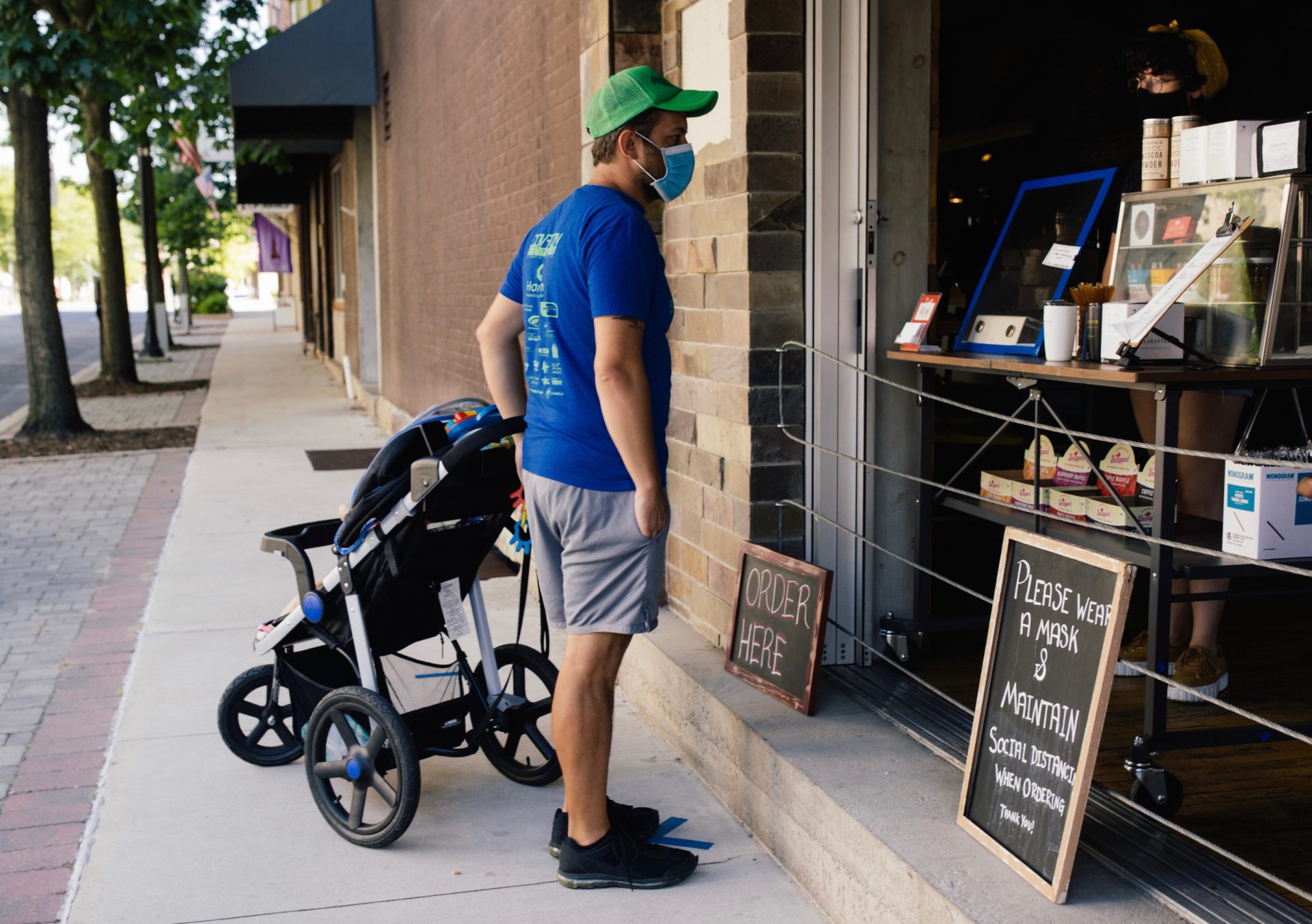 A customer places an order from the sidewalk at Alabaster Coffee Roaster & Tea Company in Williamsport on July 19, 2020.