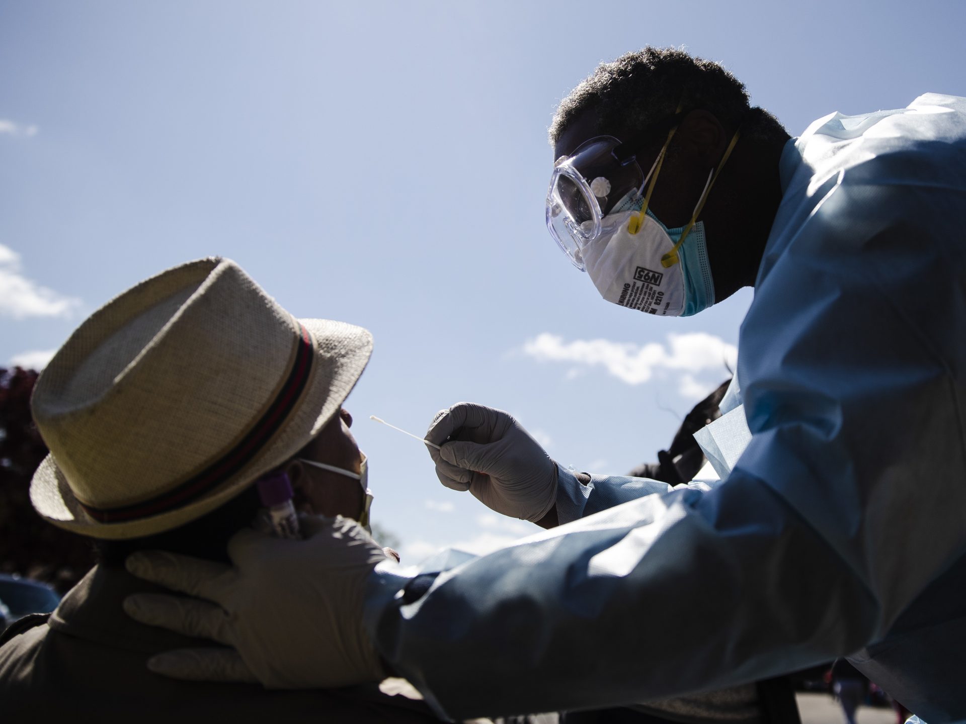 Dr. Pierre Chanoine administers a COVID-19 swab test on a person outside the Pinn Memorial Baptist Church in Philadelphia in April. The group Black Doctors COVID-19 Consortium offers testing at various locations to help address heath disparities in African American neighborhoods.