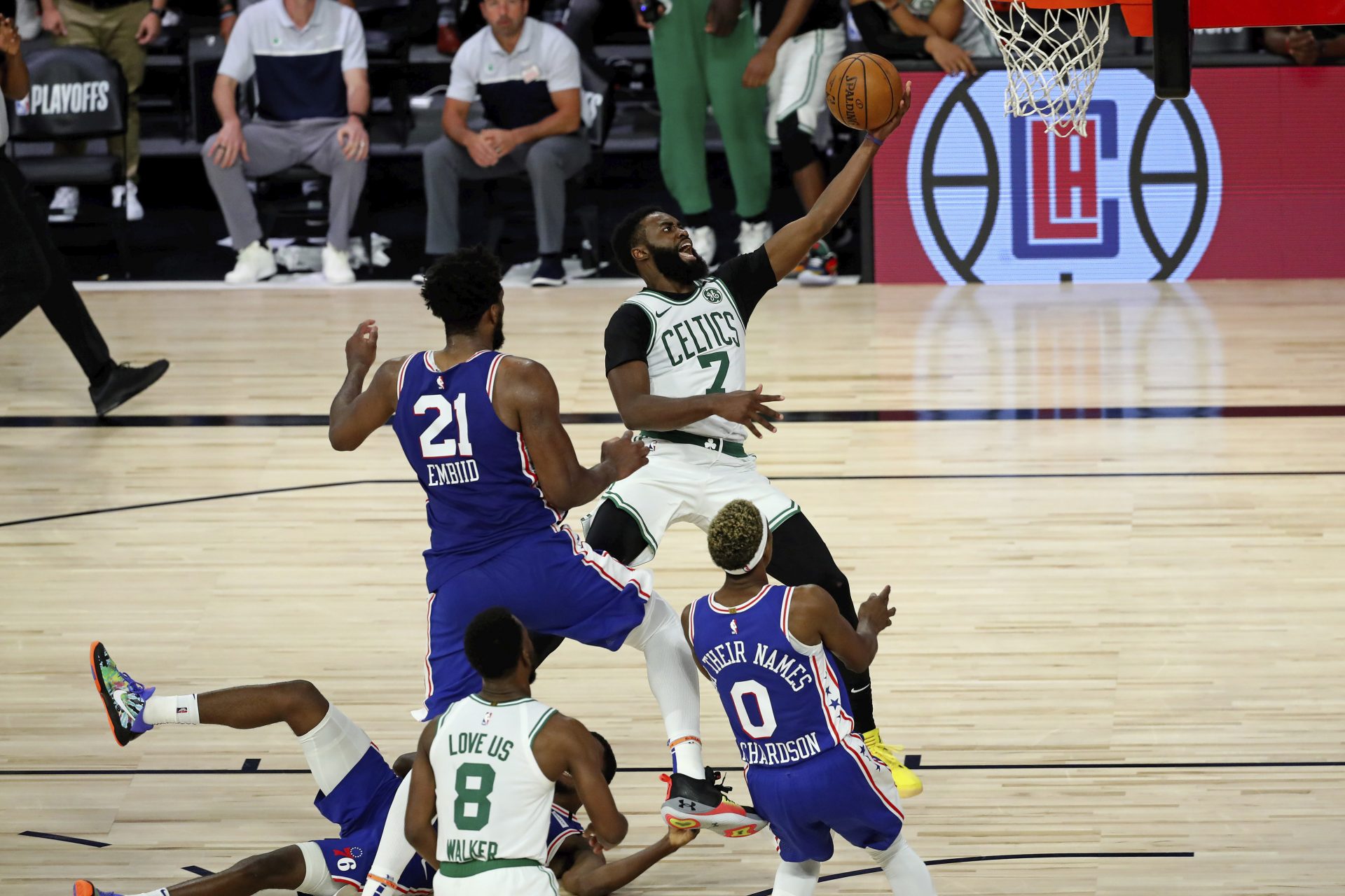 Boston Celtics guard Jaylen Brown (7) shoots the ball ahead of Philadelphia 76ers center Joel Embiid (21) during the second half in Game 3 of an NBA basketball first-round playoff series, Friday, Aug. 21, 2020, in Lake Buena Vista, Fla.