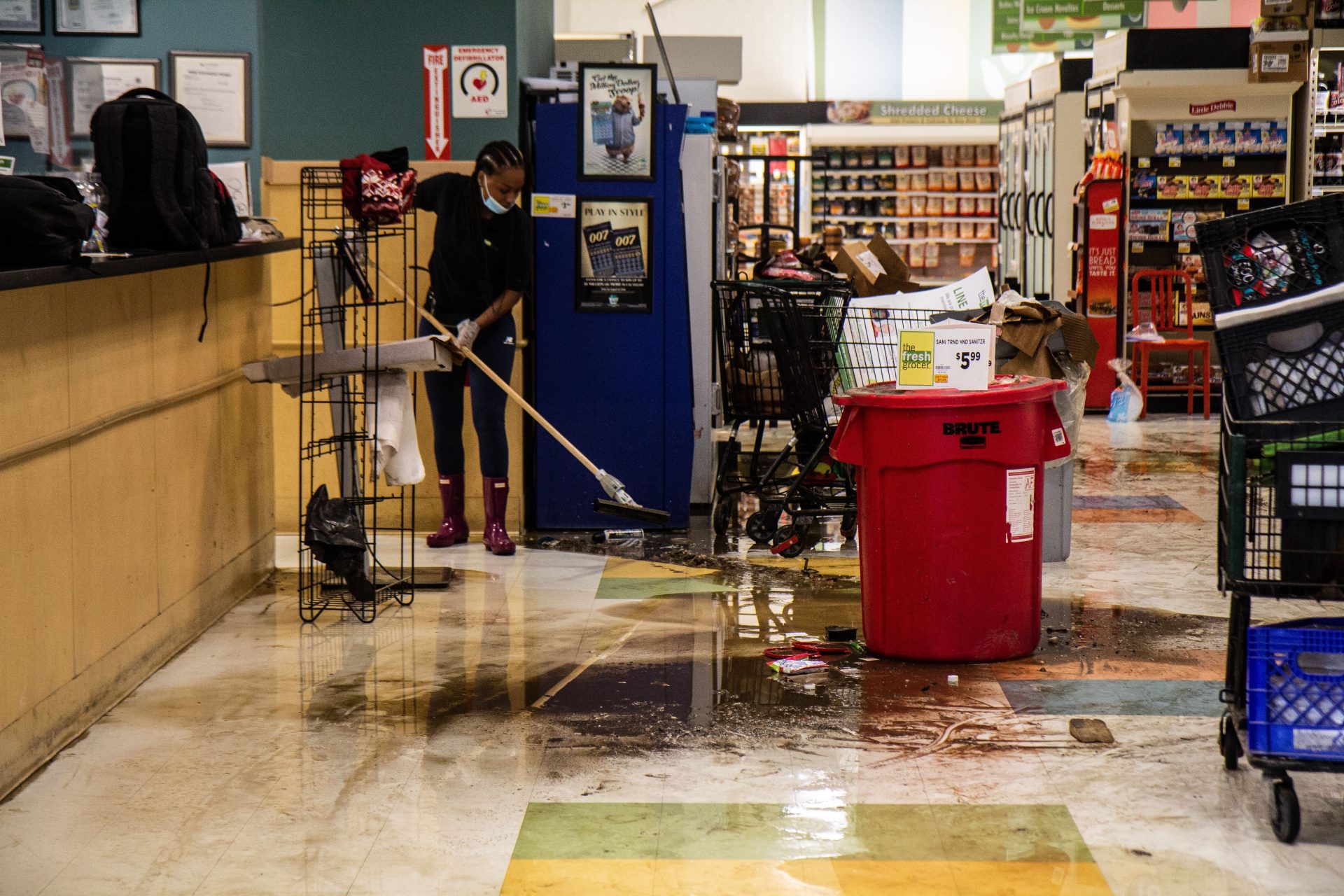 A Fresh Grocer employee uses a squeegee to clean-up after Isaias brought flooding to the Upper Darby store.