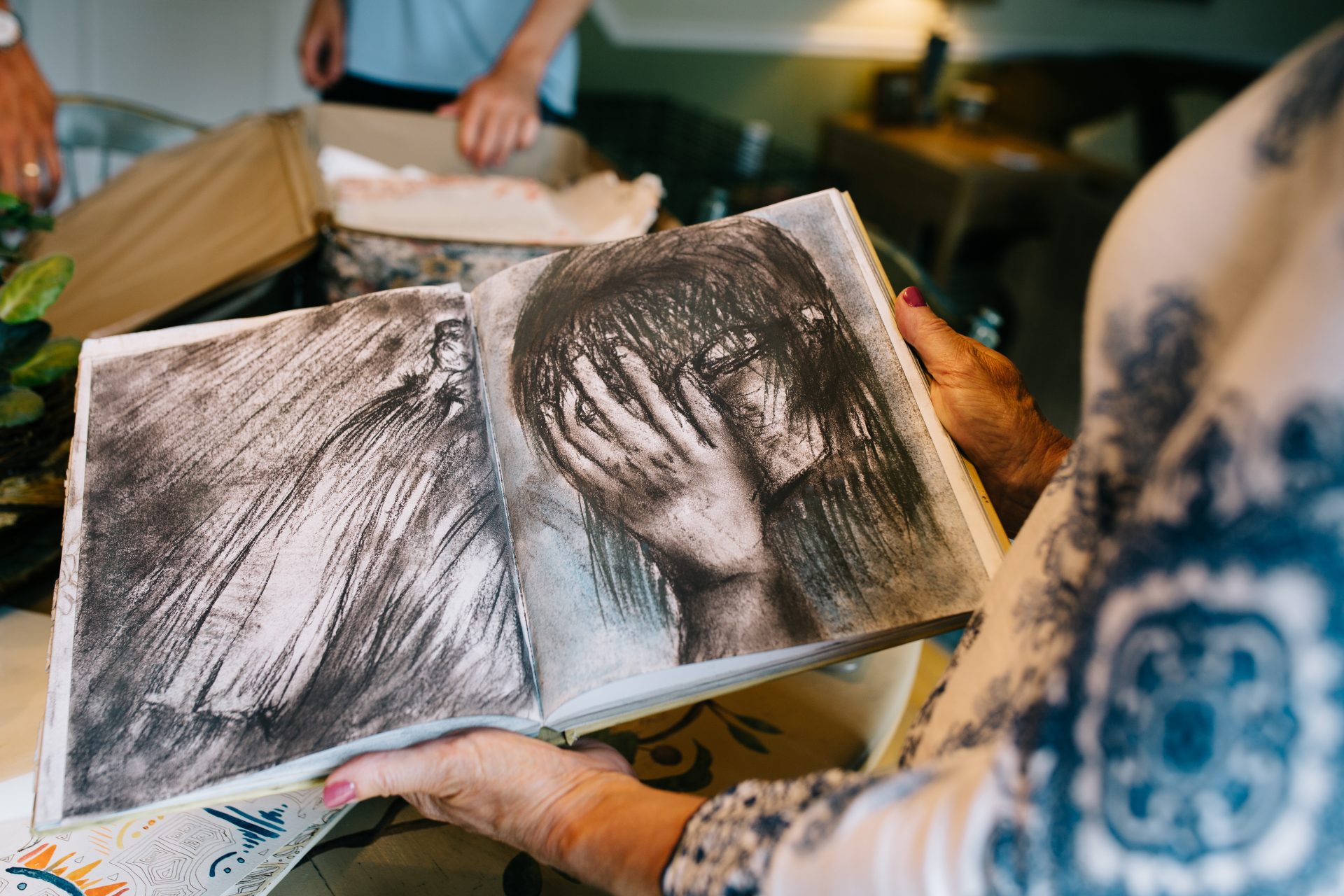 Martha Stringer shows some of Kimberly's art from high school in their home in Morrisville, Pa., on August 7, 2020.