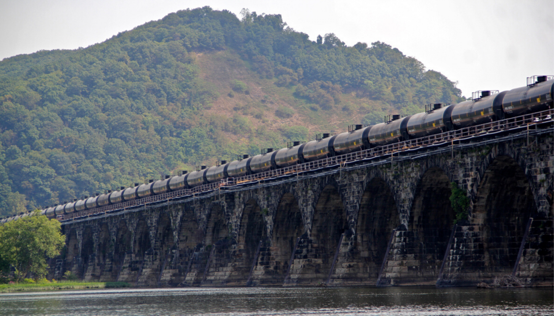 A tanker train crosses the Susquehanna River in Pennsylvania. A proposed new rule that would allow liquefied natural gas to be transported by rail is being challenged because safety and risk assessments have not been done.