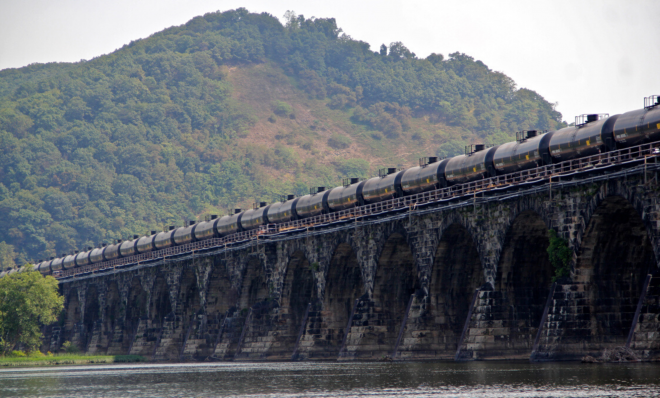 A tanker train crosses the Susquehanna River in Pennsylvania. A proposed new rule that would allow liquefied natural gas to be transported by rail is being challenged because safety and risk assessments have not been done.