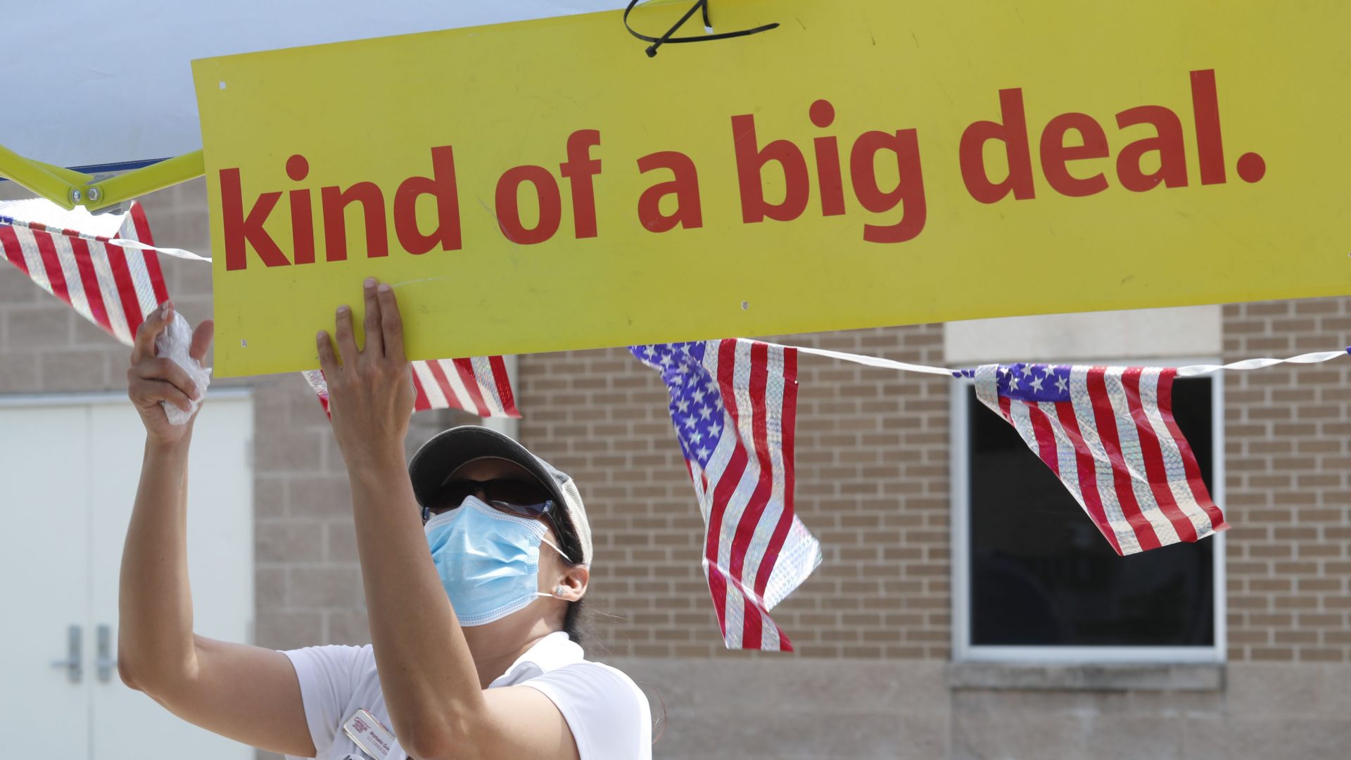 U.S. Census Bureau worker Marisela Gonzales adjusts a sign at a walk-up counting site for the 2020 census in Greenville, Texas, in July.