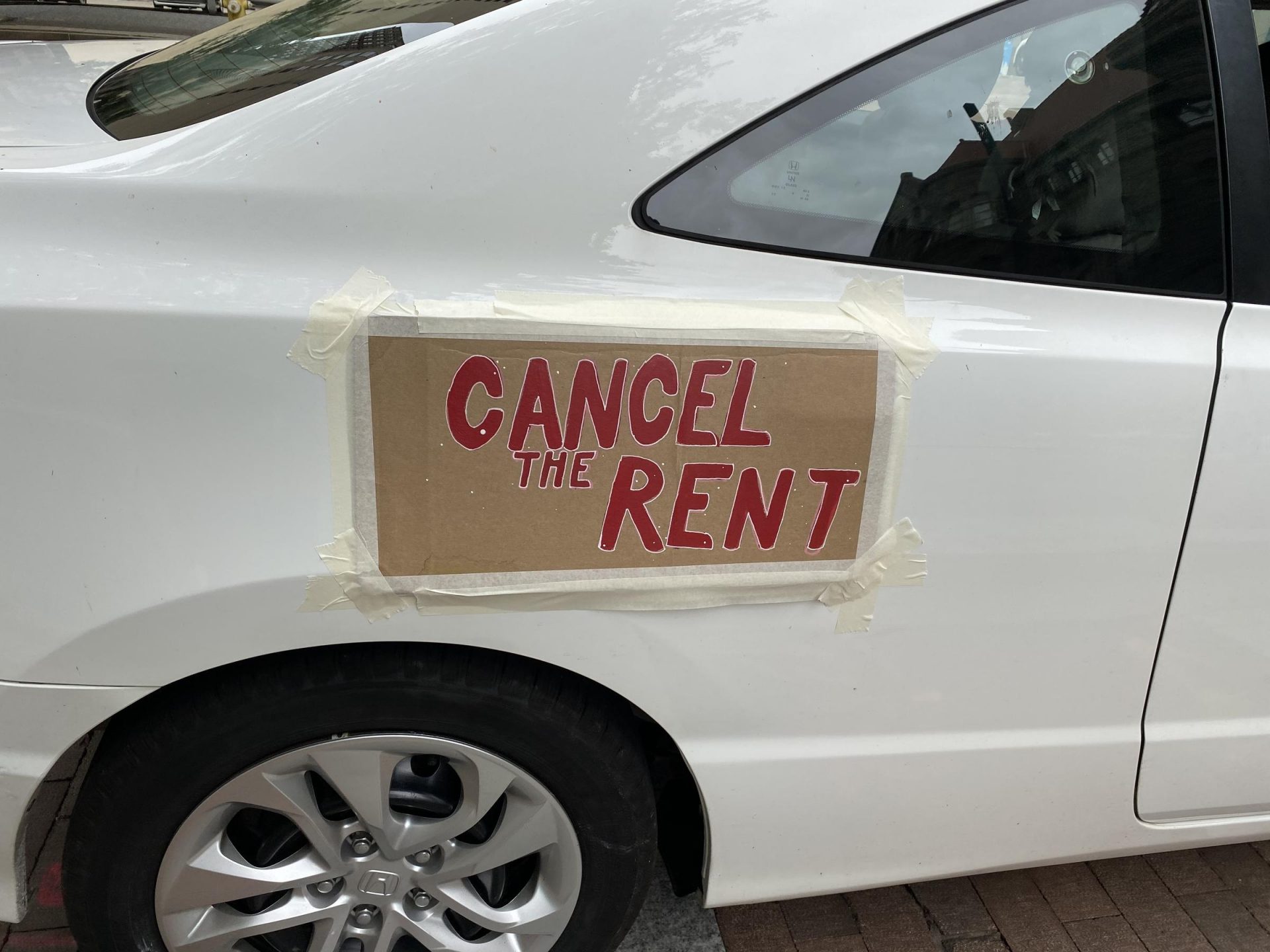 A "cancel the rent" sign is seen on a car at a rally to extend an eviction moratorium in downtown Pittsburgh on Monday, Aug. 31, 2020.