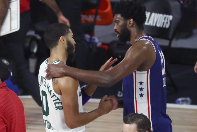 Boston Celtics forward Jayson Tatum (0) speaks with Philadelphia 76ers center Joel Embiid (21) after Game 4 of an NBA basketball first-round playoff series, Sunday, Aug. 23, 2020, in Lake Buena Vista, Fla.