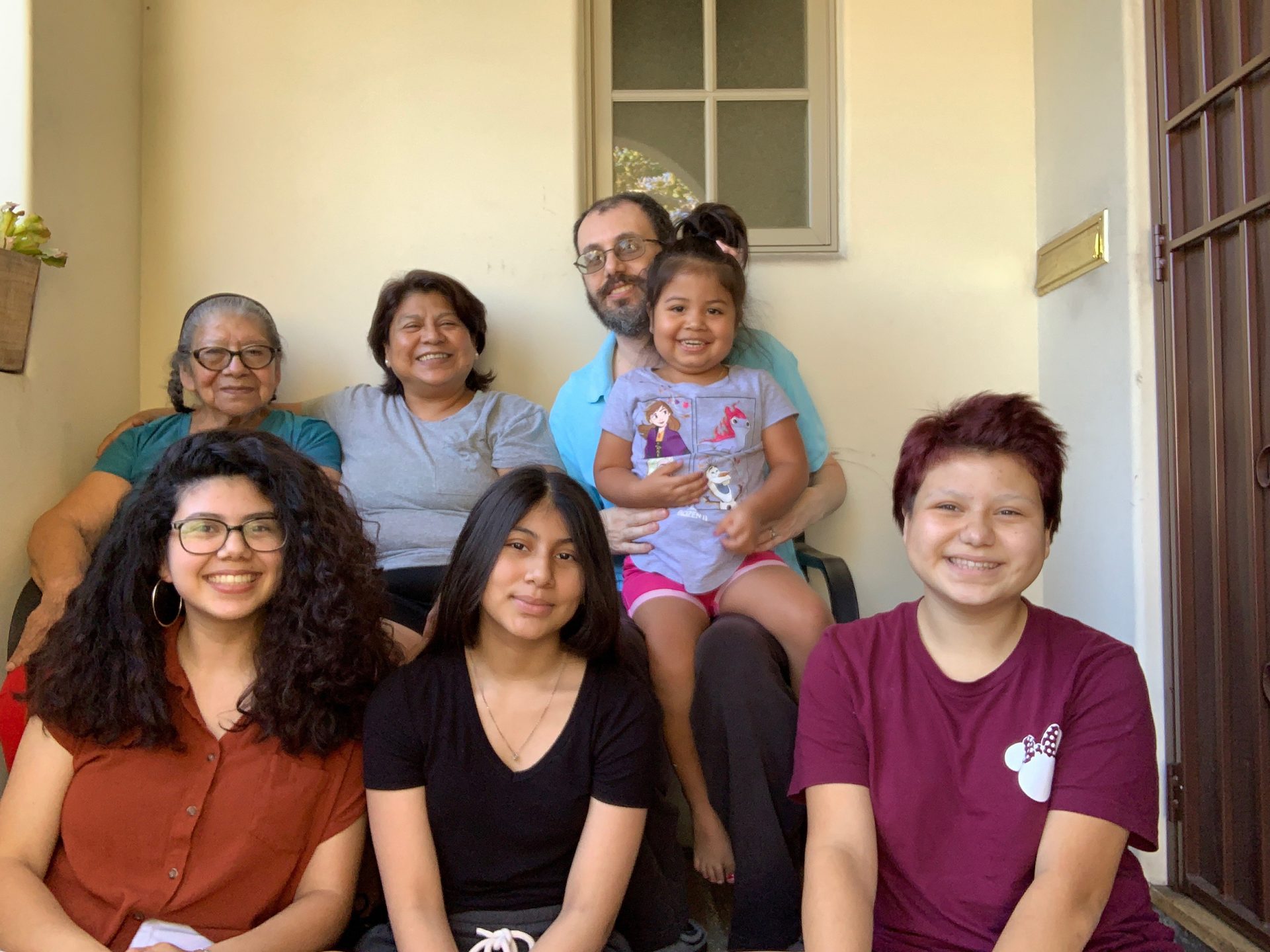 Maria Hernandez (top row, second from left) and her extended family live together in Los Angeles. When she was diagnosed with the coronavirus, she self-isolated in an upstairs bedroom.