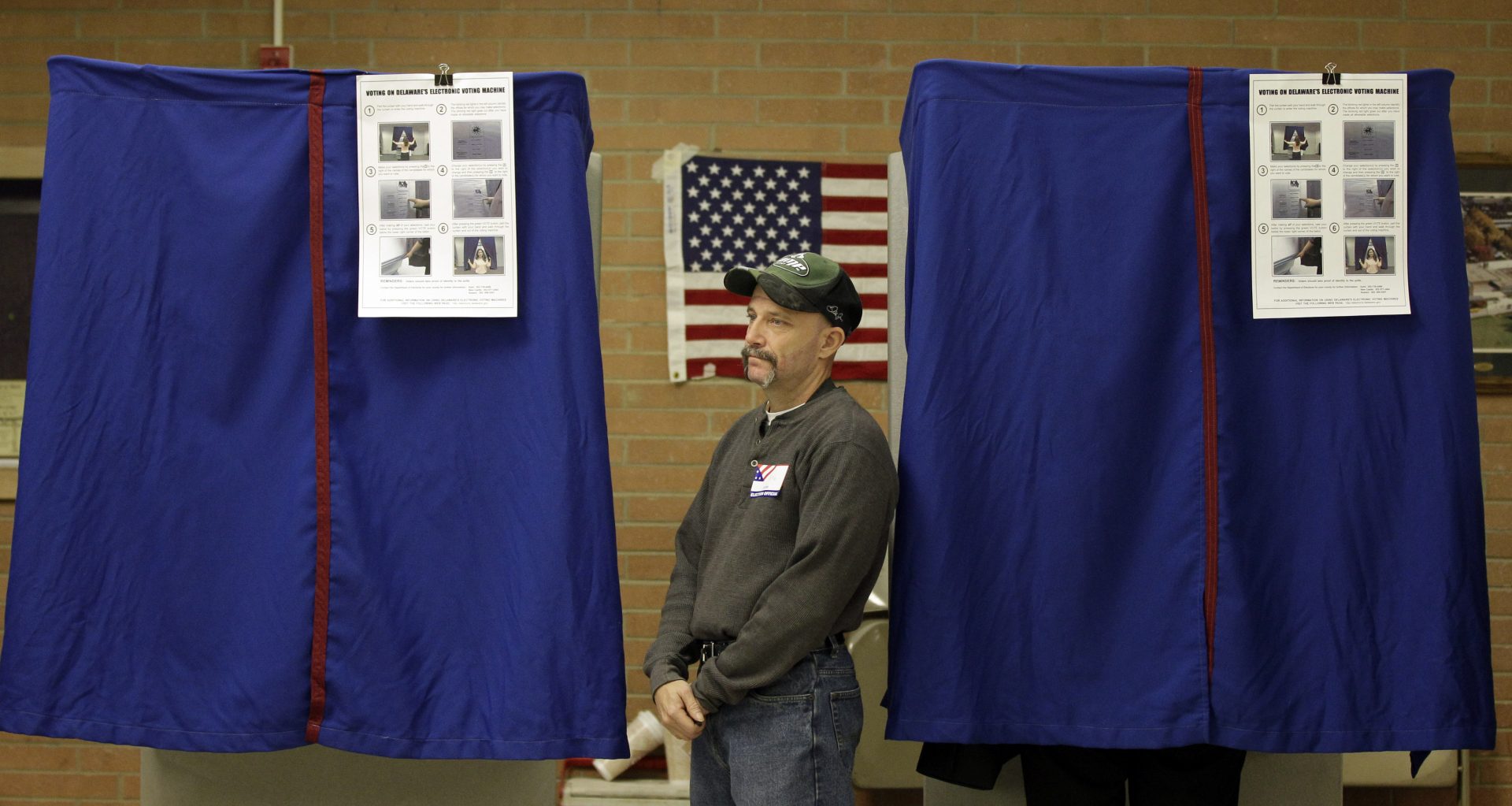 An election worker monitors a voting booth at a polling station in Wilmington, Del. Tuesday, Nov. 2, 2010.