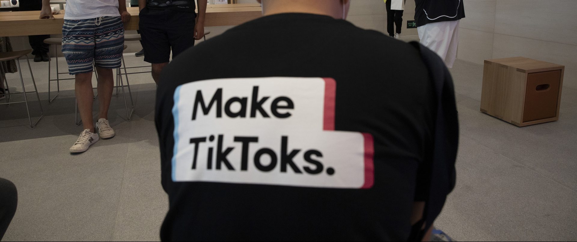 A man wearing a shirt promoting TikTok is seen at an Apple store in Beijing on Friday, July 17, 2020. U. S. President Donald Trump says he wants to take action to ban TikTok, a popular Chinese-owned video app that has been a source of national security and censorship concerns.