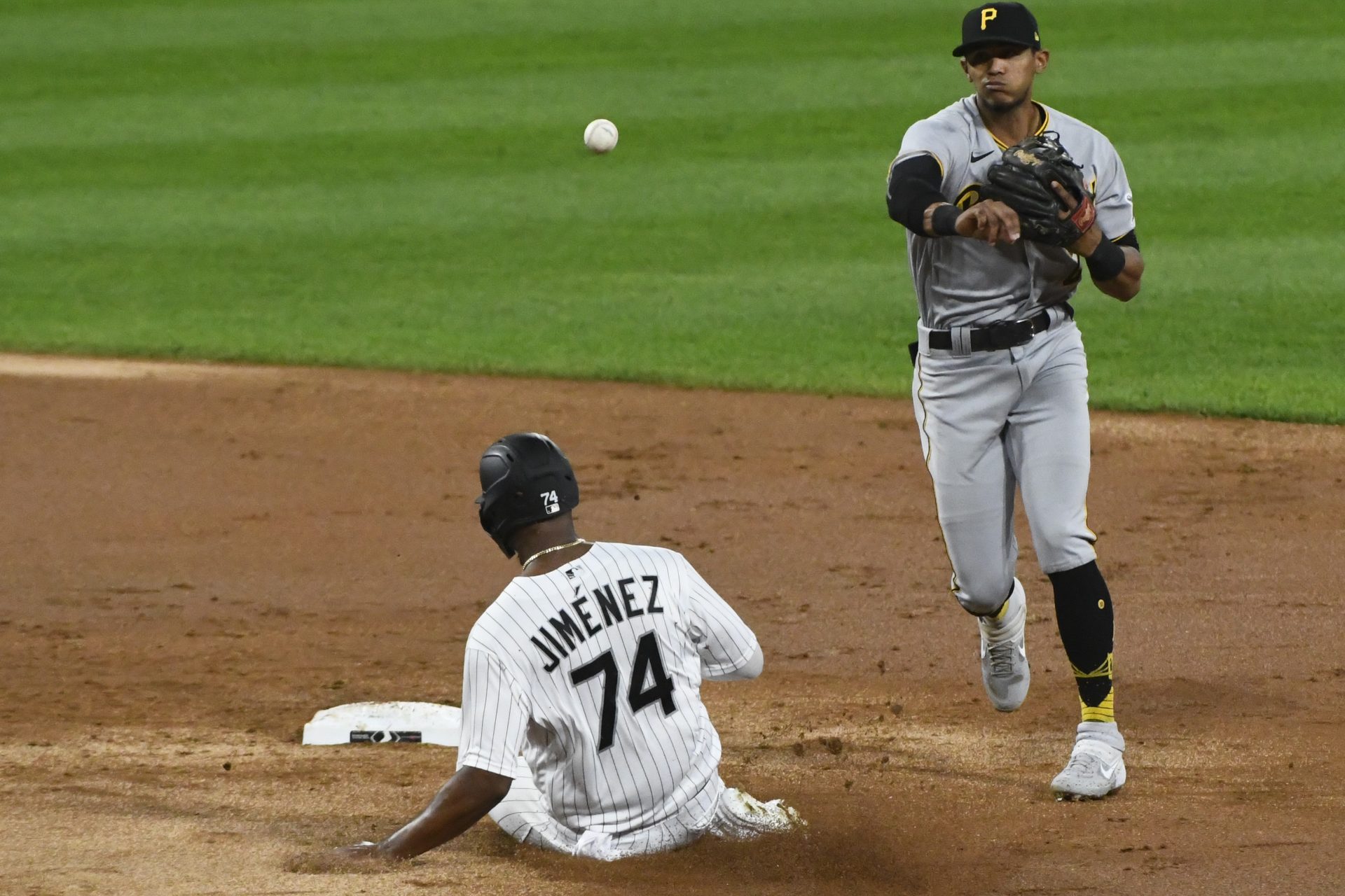 Pittsburgh Pirates second baseman Erik Gonzalez (2) completes a double play after forcing Chicago White Sox left fielder Eloy Jimenez (74) out during the second inning of a baseball game, Tuesday, Aug. 25, 2020, in Chicago.