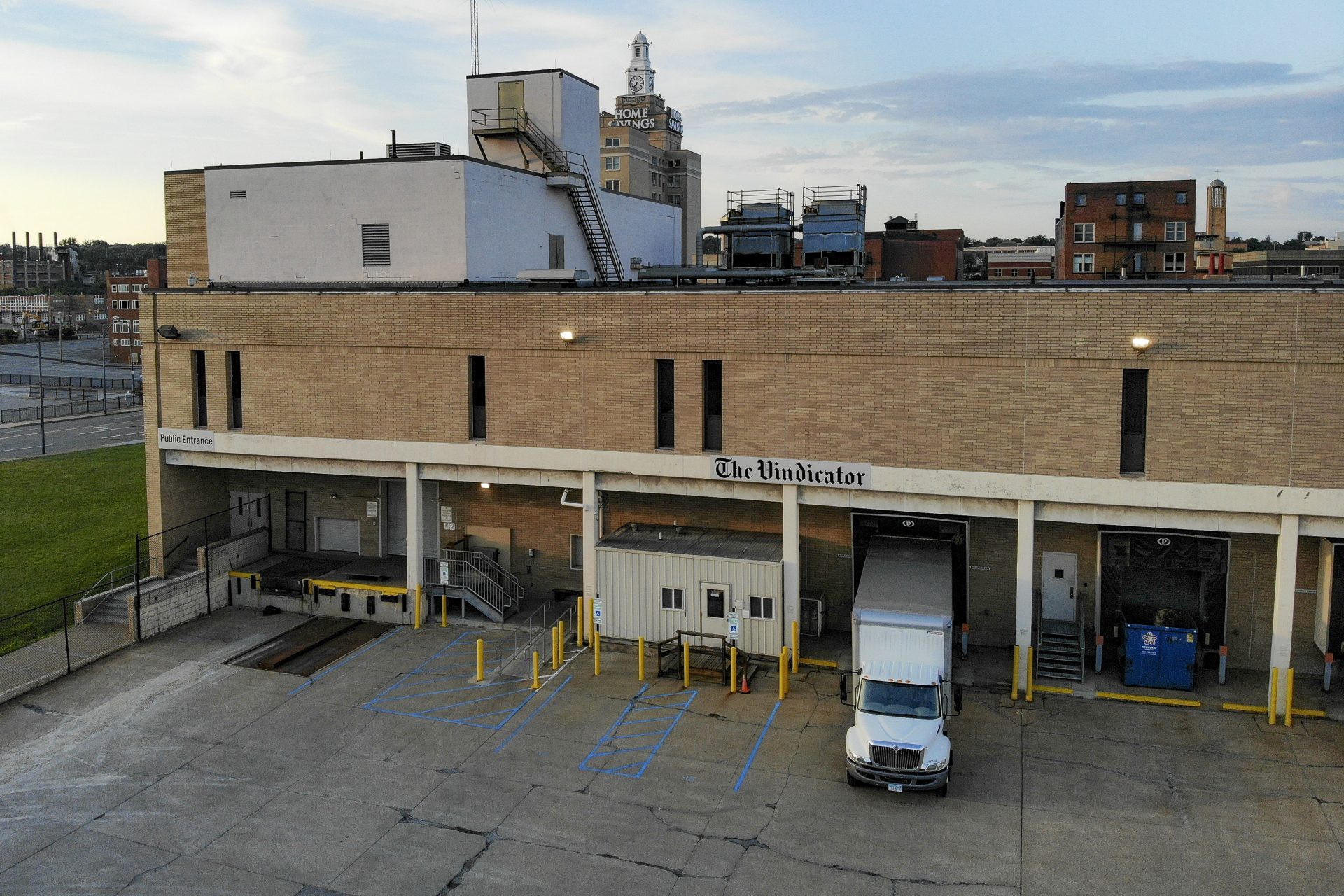 In this Wednesday, Aug. 14, 2019, photo, a truck is parked at the loading docks of the Vindicator printing depot in Youngstown, Ohio. The Youngstown paper announced in June it would cease publication Saturday, Aug. 31, because of financial struggles, but the paper will be printed by the Tribune Chronicle, which has bought The Vindicator name, subscriber list and website from owners of the Youngstown publication.